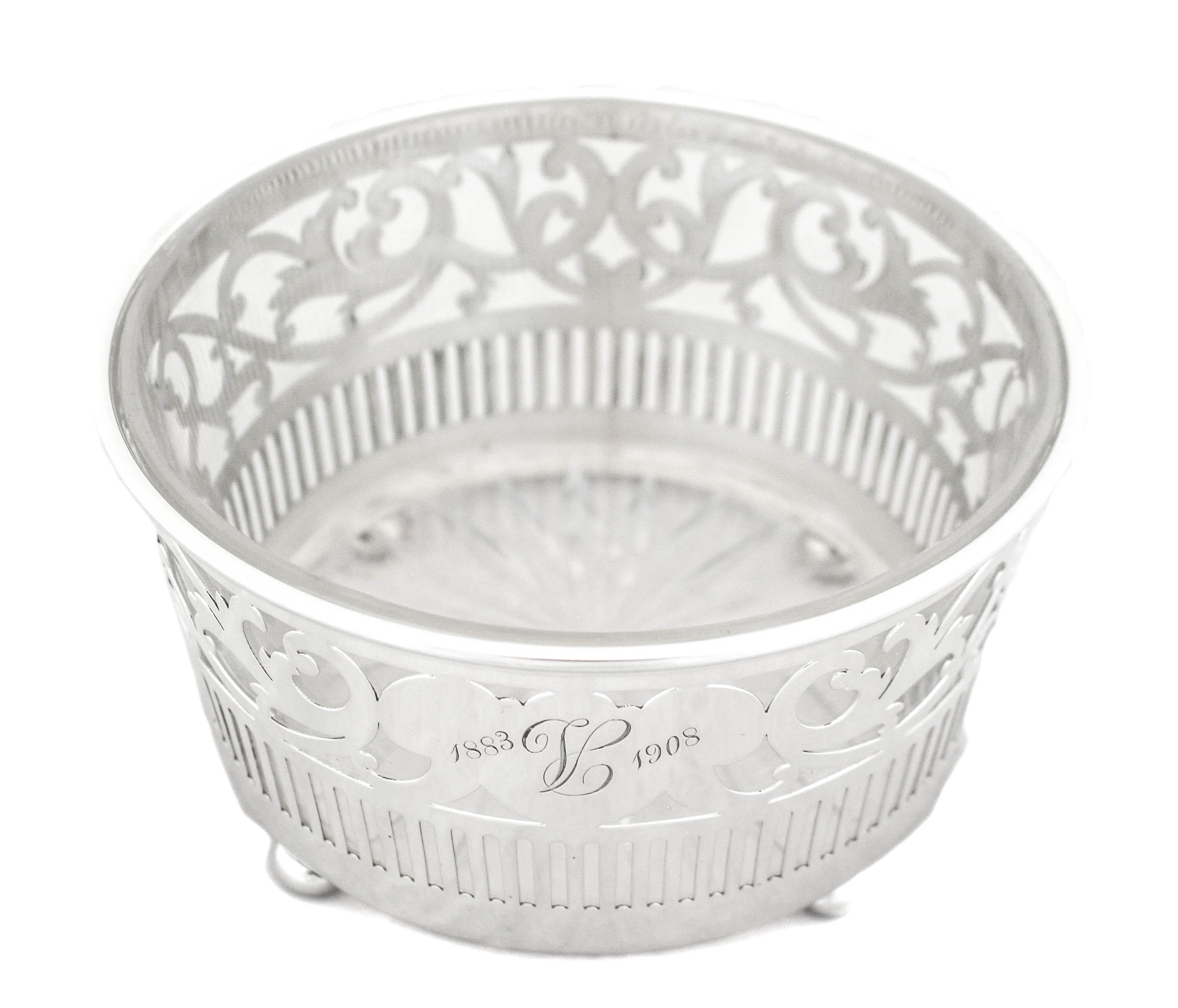 This sterling silver ice bucket by Reed and Barton is a gorgeous piece to have on your table or bar. Hand engraved “1883-1908”, it was gifted as a twenty fifth silver wedding anniversary gift. It has a reticulated pattern with a clear glass liner