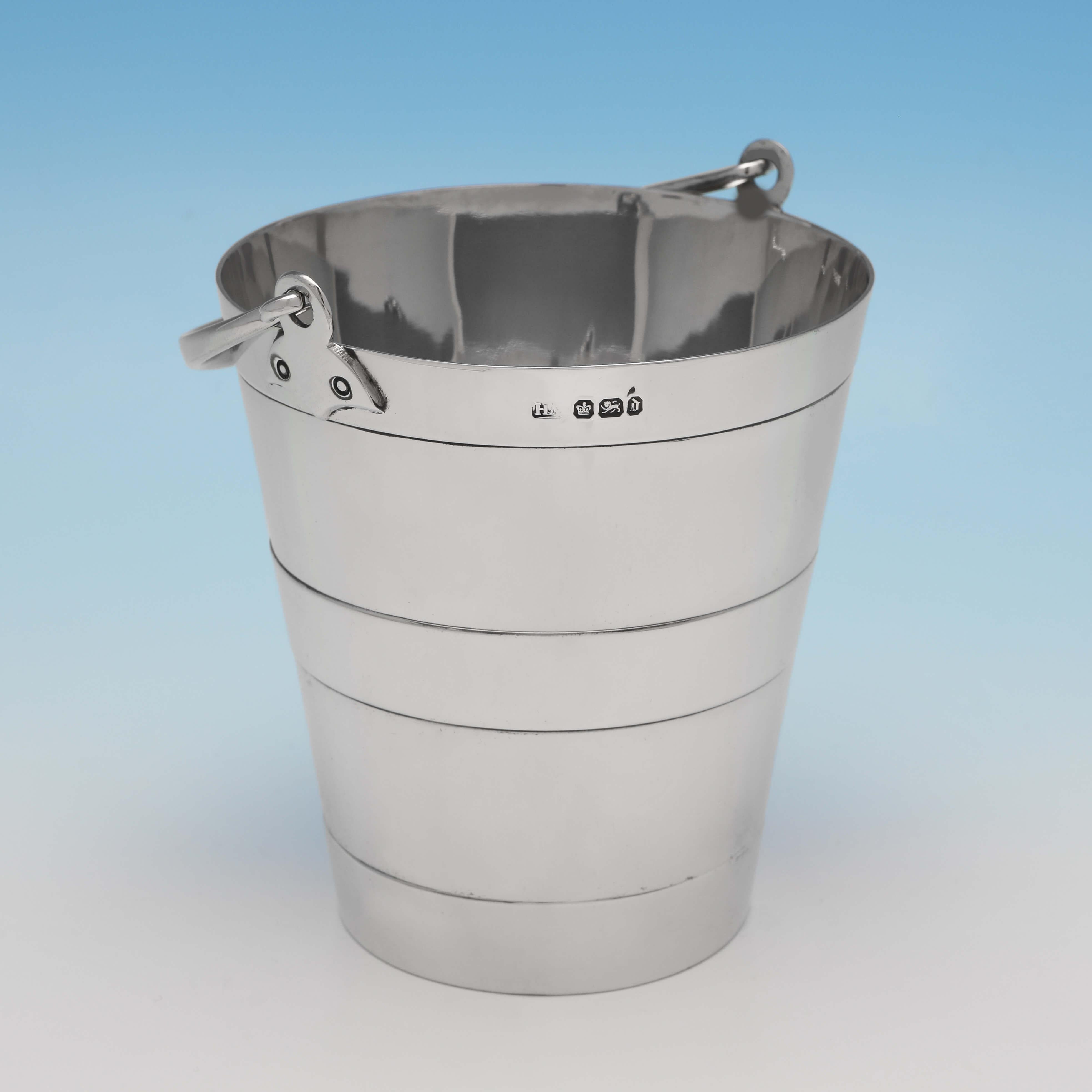 Hallmarked in Sheffield in 1896 by Henry Atkin, this very handsome, Victorian, antique sterling silver ice bucket, is plain in style, and bucket shaped. The ice bucket measures 4.75