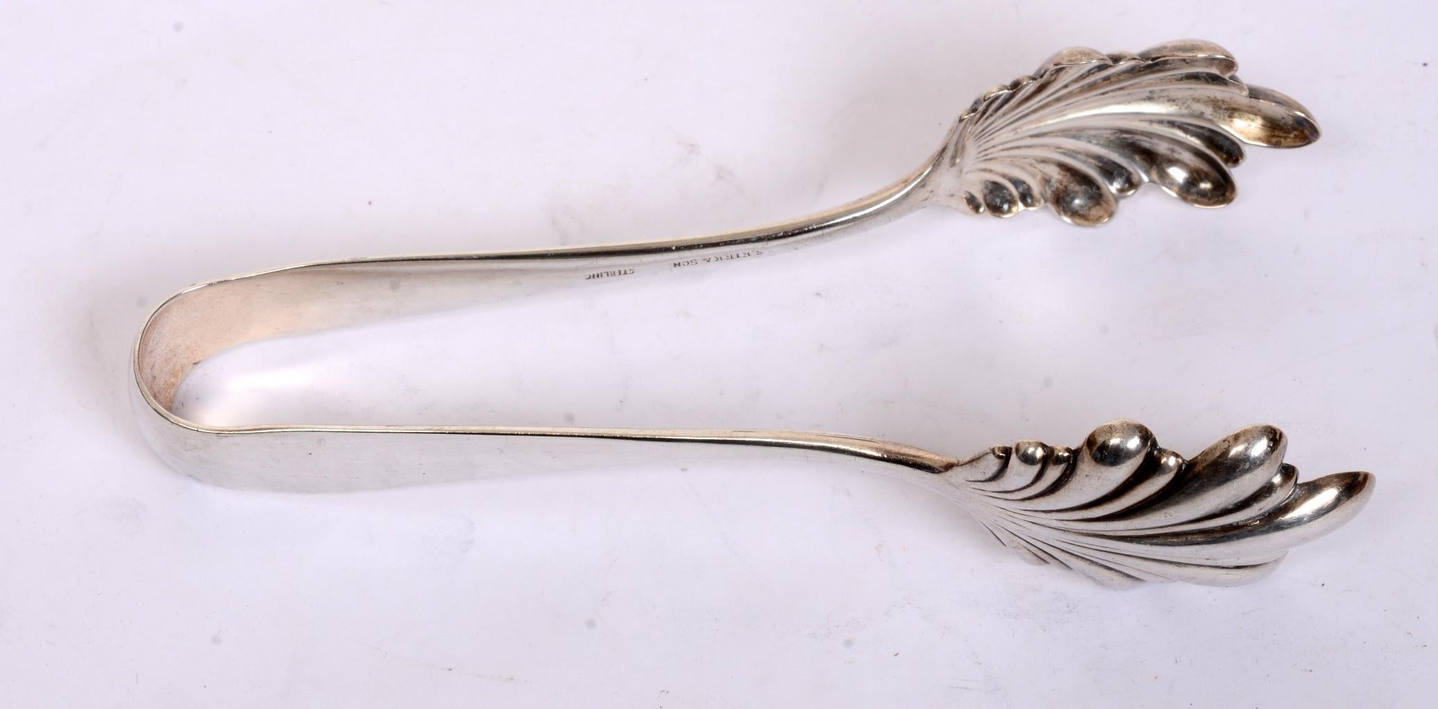 Sterling silver ice tongs by Kirk, “Old Maryland Plain”, late 19th century. This pattern, originally designed in 1850, is one of the oldest patterns of Baltimore silver. Because it is so simple, it can be used in both colonial or contemporary
