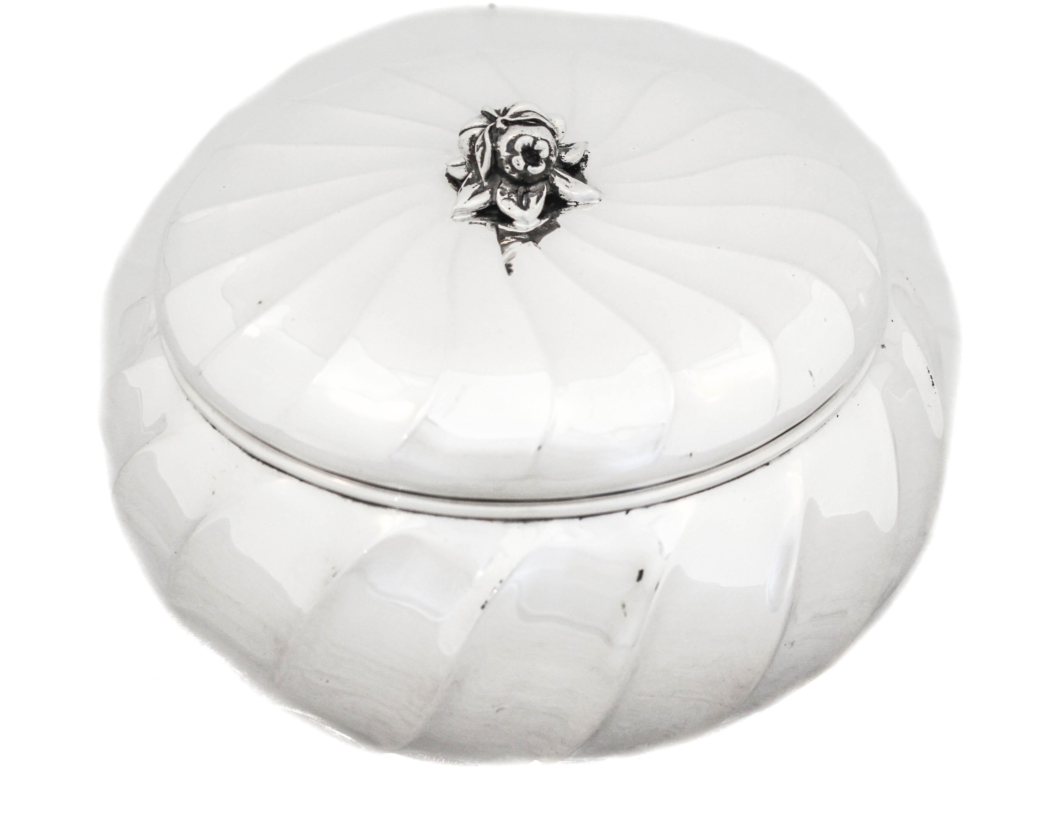 Being offered is a sterling silver box made in Italy in the 1960’s.  It is round with a swirl pattern all around the side and cover.  The finial is a cluster of flowers in the center.  The swirl design gives this piece a modern feel.  The inside is