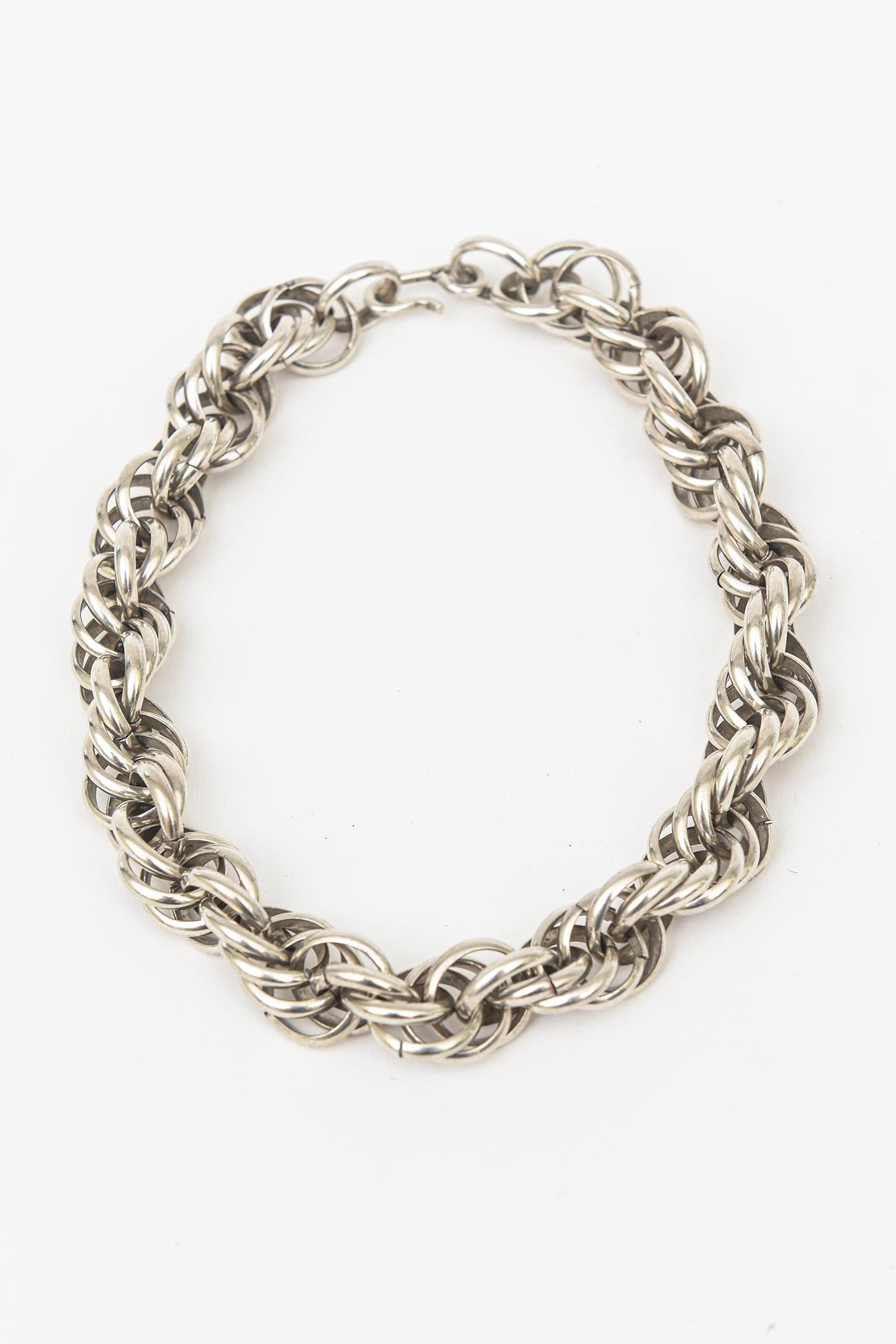 This sterling silver chic Italian twisted link necklace is vintage and hallmarked but not legible. The choker collar necklace is timeless. It says 25T the 9 not visible to show the sterling mark. It has been tested by a jeweler for sterling silver