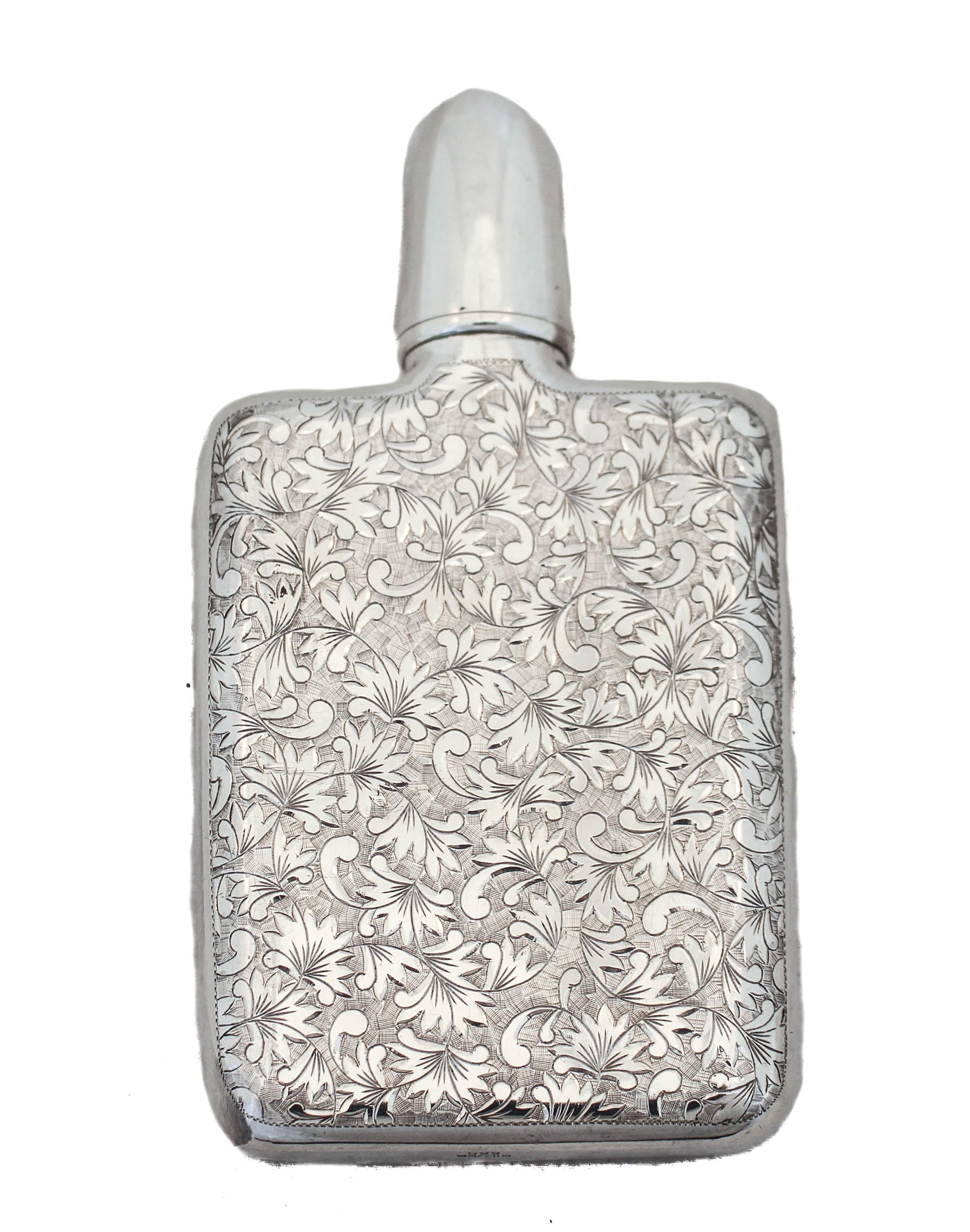 We’re delighted to offer you this sterling silver Japanese flask. It has beautiful etched detail on both the front and back. It’s three dimensional with some of the work raised against a backdrop of etching. The front also has a cartouche— a place