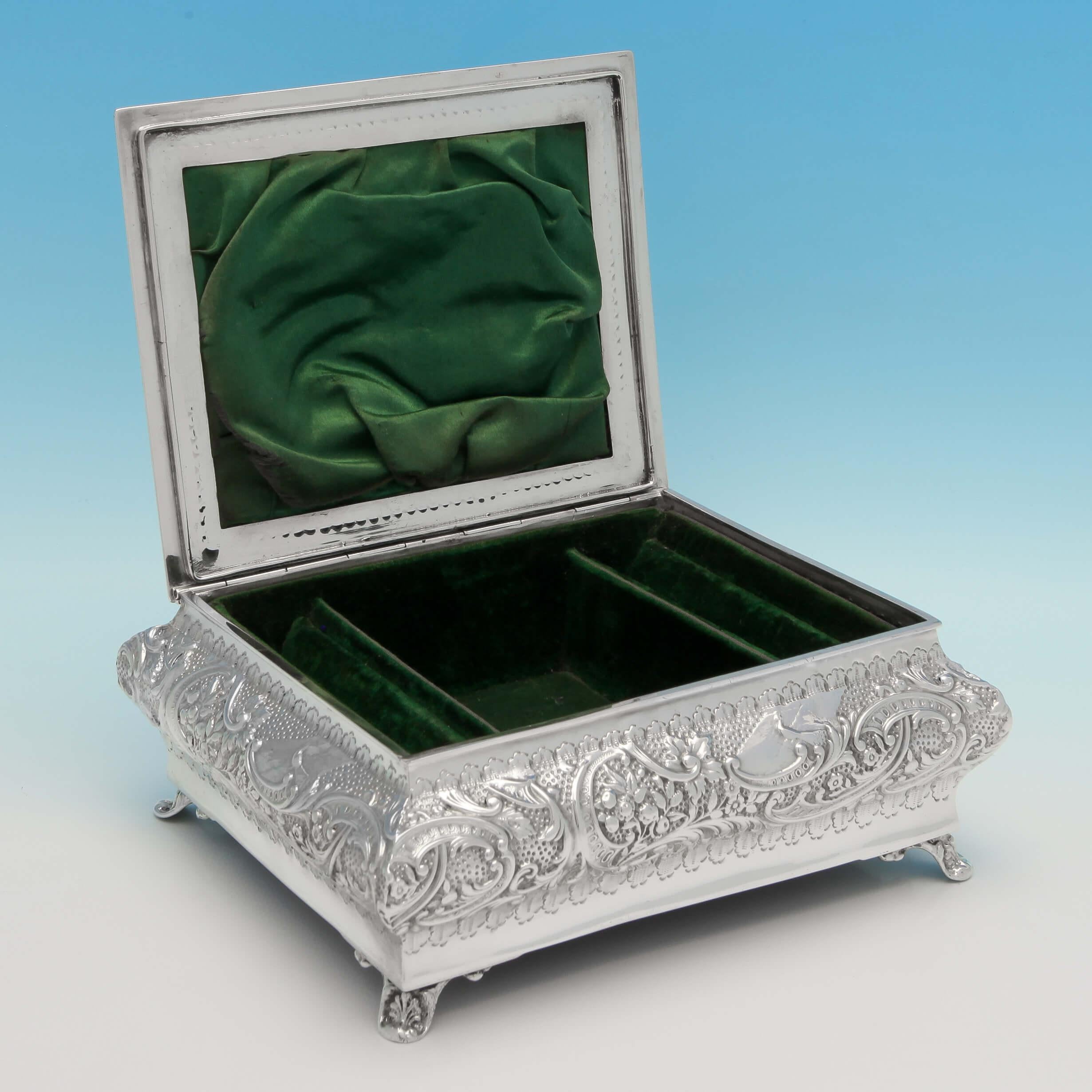 Hallmarked in London in 1902 by Henry Matthews, this fantastic, Edwardian, Antique Sterling Silver Jewellery Box, features a green velvet lined interior with slots for rings, chased decoration throughout, and a scene on the lid depicting two ladies