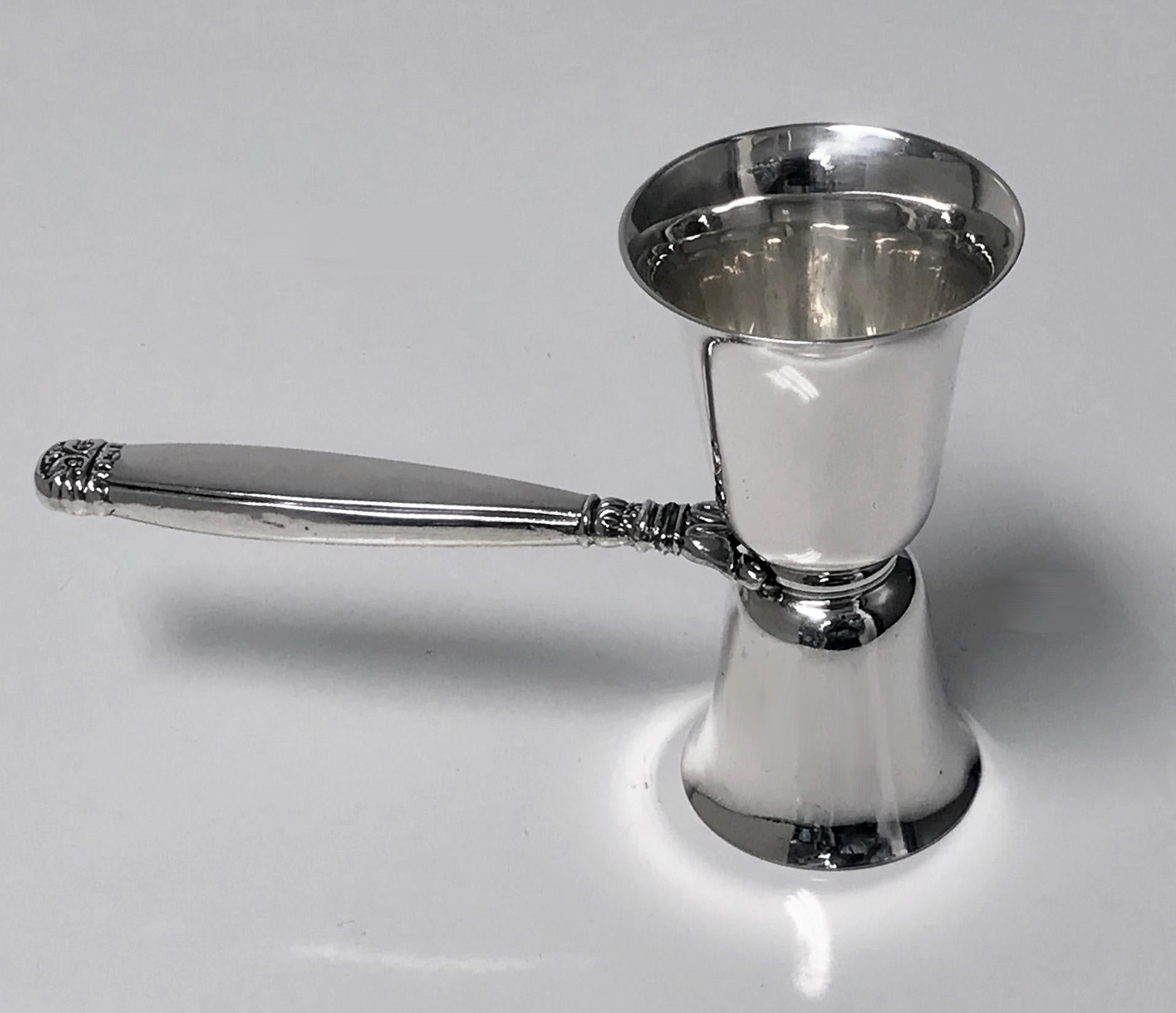 Double sterling silver Jigger Barware Birks 1950. Double two size measure, plain with acanthus terminal handle. Stamped Birks Sterling with full marks for 1950. Measures: 5.50 x 3.75 inches. Weight: 69.81 grams.