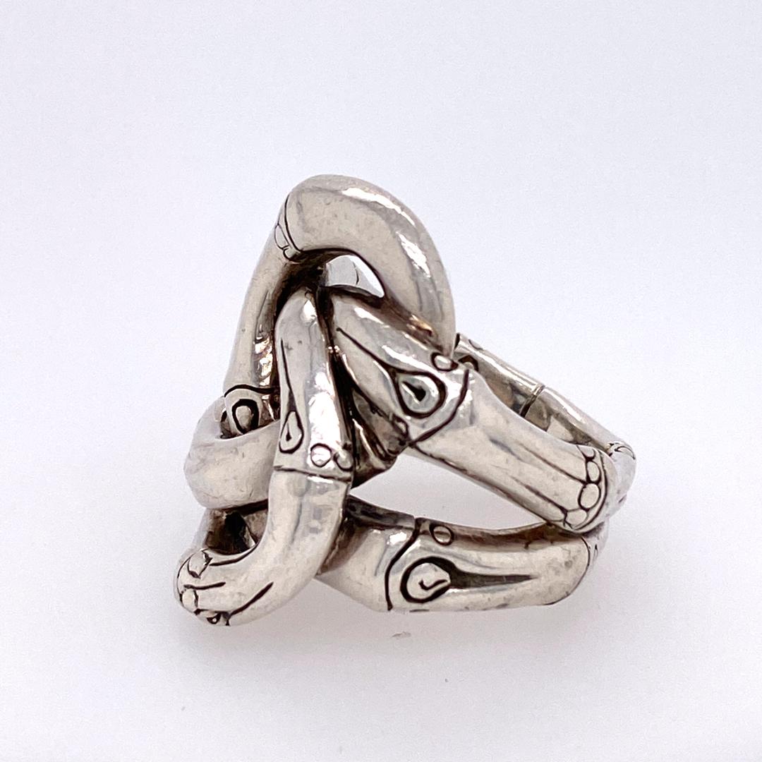 Designer John Hardy Bamboo Knot Ring in Sterling Silver.  The knot is 1 inch in length and 5/8 inch width.  Ring size 7.  22.08 grams.  Signed.