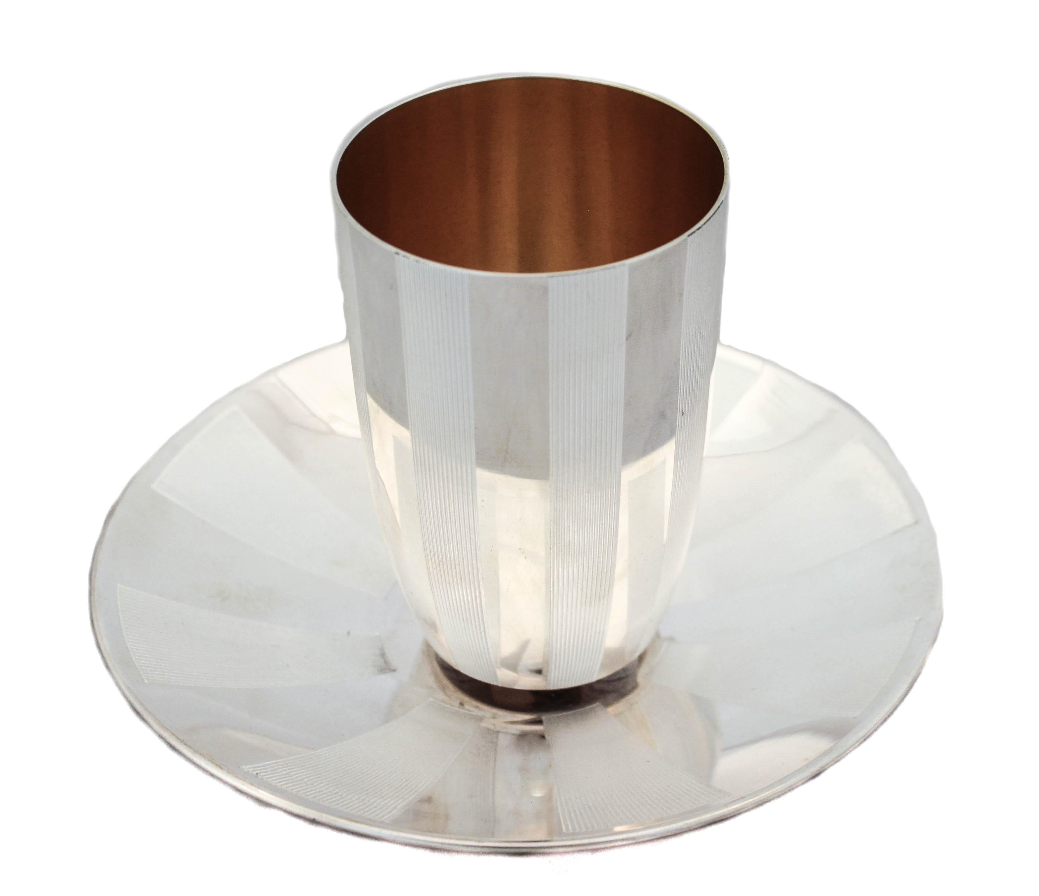 We are delighted to offer you this sterling silver (Kiddush) goblet and matching plate.  Made in Israel it is modern and sharp.  It has a striped design; alternating between the two.  The stripes have finely engraved ridges that give it texture. 
