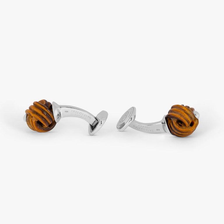 Sterling Silver Knot Cufflinks with Tiger Eye

Hand-carved pieces of tiger eye semi-precious stone take the shape of a traditional knot, one of the oldest forms of cufflinks. Tiger eye is famous for its golden yellow colour and is commonly
