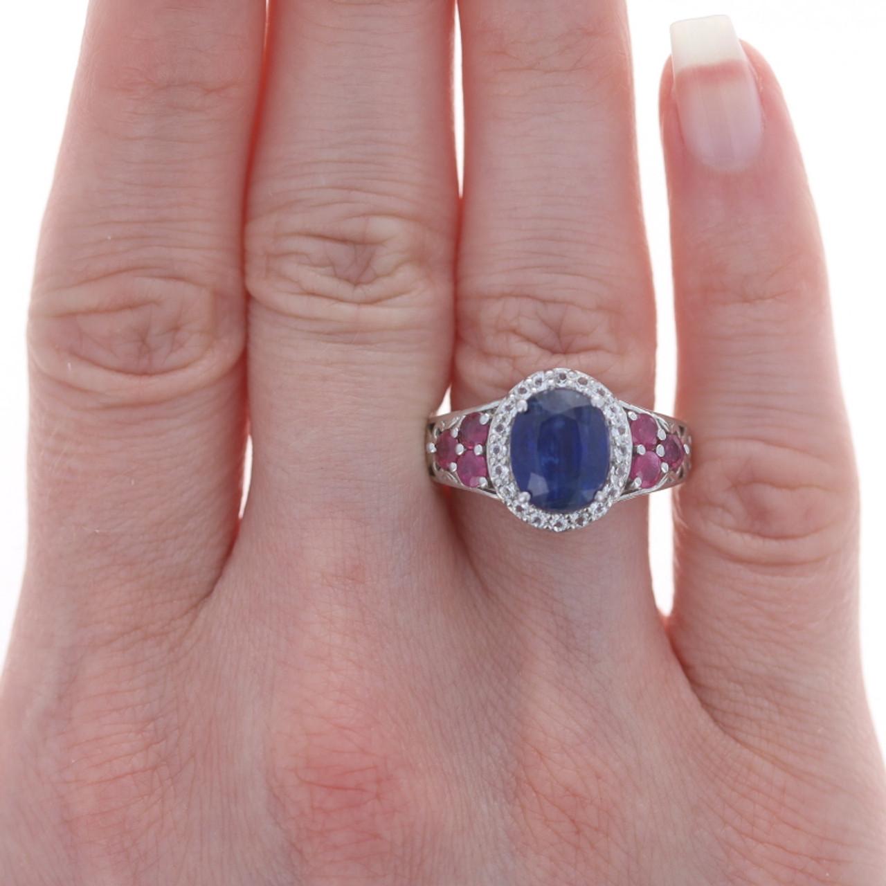 Sterling Silver Kyanite, Ruby, & White Topaz Halo Ring 925 Oval Cut

Stone Information:
Natural Kyanite
Cut: Oval
Color: Blue

Natural Rubies
Treatment: Lead Glass Filled & Heated
Cut: Round
Color: Pinkish Red

Natural White Topaz
Cut: