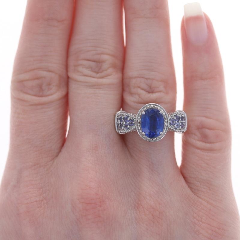 Sterling Silver Kyanite, Tanzanite, & White Topaz Ring 925 Oval Cut Milgrain

Stone Information:
Natural Kyanite
Cut: Oval
Color: Blue

Natural Tanzanites
Treatment: Routinely Enhanced
Cut: Round
Color: Purple

Natural White Topaz
Cut: