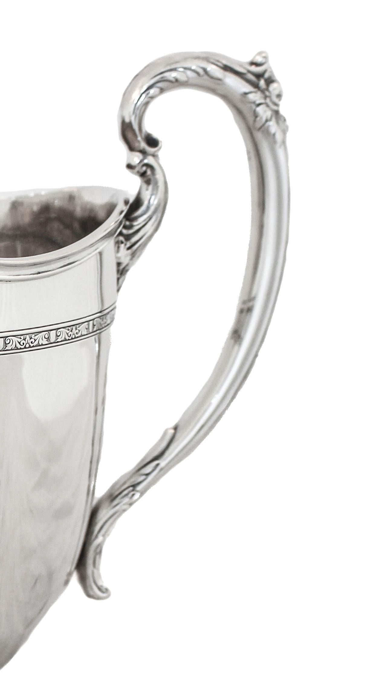 Being offered is a sterling silver water pitcher in the “Lady Constance” pattern by Towle Silversmiths. It has a big rounded-belly and can hold seven pints of water (most water pitchers hold only three to four pints). It has ribbing around the