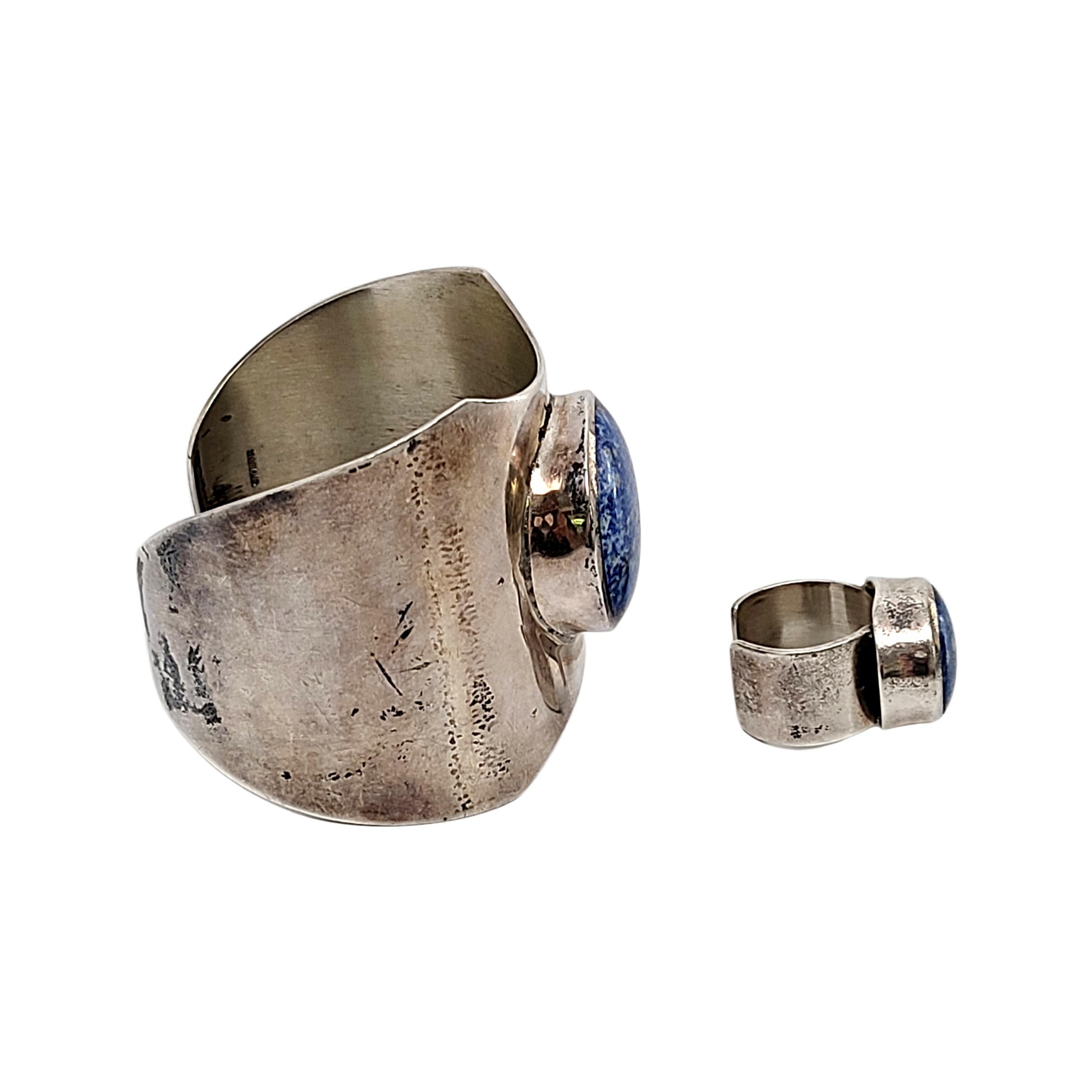 Sterling silver and lapis lazuli ring and cuff bracelet set,

Ring size 6 1/2

Both pieces feature a beautiful large round bezel set lapis lazuli cabochon. The cuff bracelet is a wide band that tapers from the front to the back.

Cuff bracelet