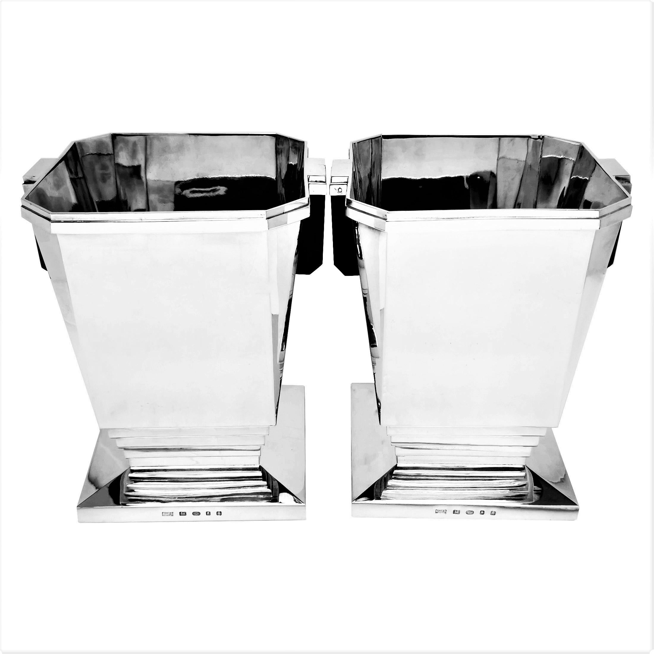 A pair of magnificent modern Solid Silver Wine Coolers. The design of these exceptional Champagne Buckets is inspired by the clean lines and elegant sensibilities of the Art Deco period giving them a historical gravitas while appealing to modern