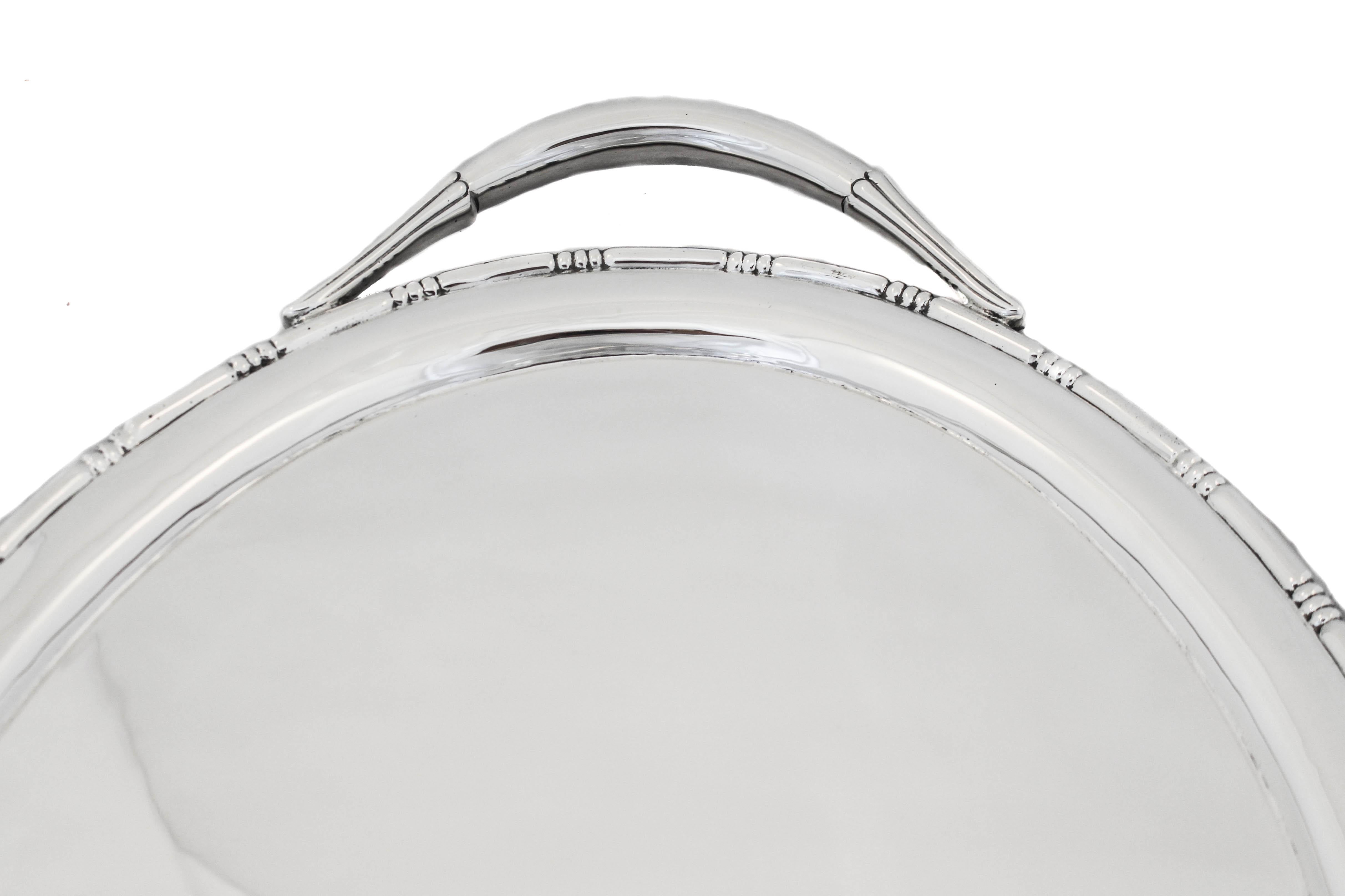 We are delighted to offer you this large sterling silver Art Deco tray from the 1920’s.  It is a large and very heavy tray that can be used for serving or under a tea set.  The pattern around the rim is a series of three-notches every one and half