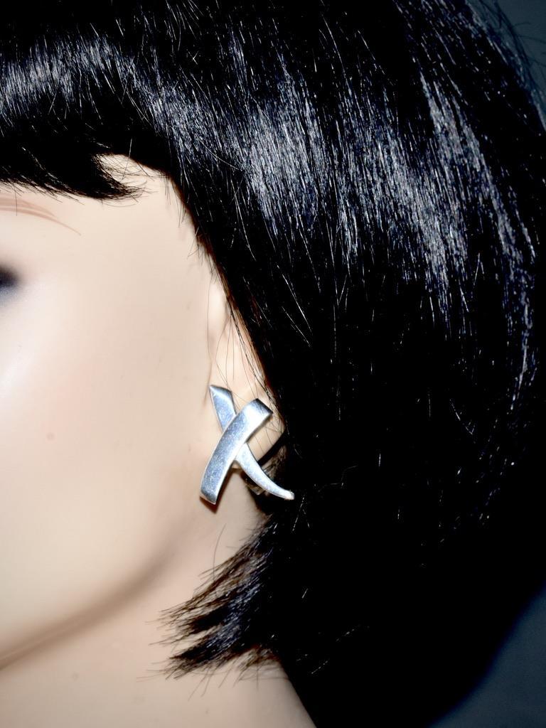 Paloma Picasso's large size 'X' or kiss earrings, vintage c 1990.  In fine condition, these earrings weigh 9.4 grams and have a length of 1.25 inches.  They are marked 925 for sterling silver.

In 1949 Pablo Picasso worked on a very important