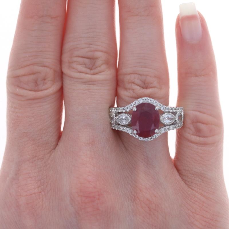 Sterling Silver Lead Glass Filled Ruby & White Topaz Ring 925 Oval Milgrain

Stone Information:
Natural Ruby
Treatments: Heated & Lead Glass Filled
Cut: Oval
Color: Pinkish Red

Natural White Topaz
Cut: Marquise & Round

Additional Information: