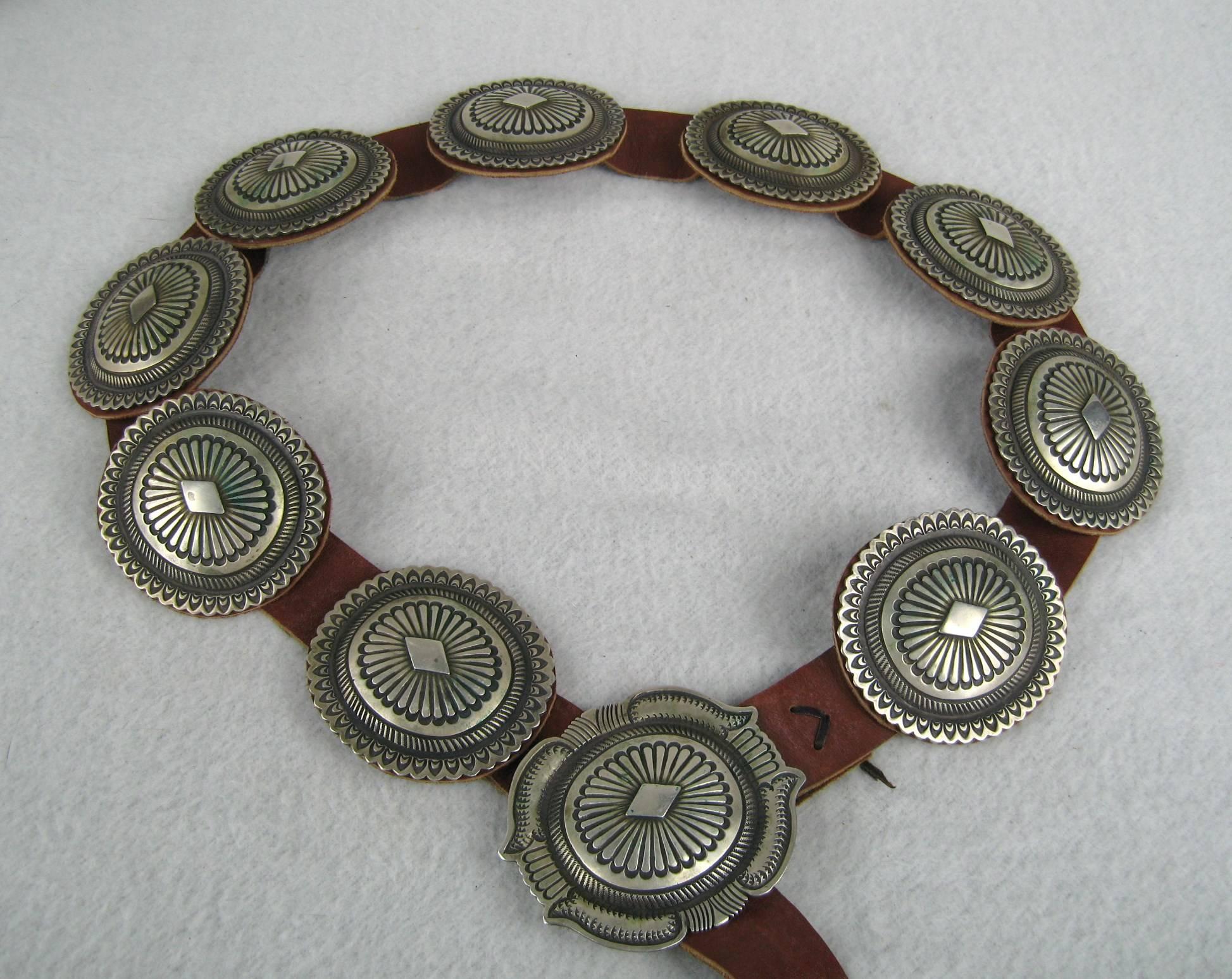 Stunning Navajo Concho Belt with 9 Concho's  and a Large Belt Buckle. Expertly Hand made by a Navajo silversmith. measuring 2.72 in  x 2.88 in. belt buckle 3.39 in wide x 2.89 in, Belt is 51 inches long. Belt holes start at 30 to 33 inches. Can be