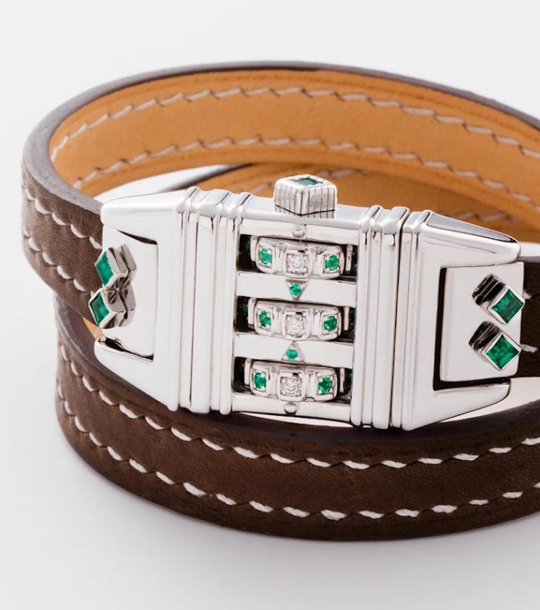 Sterling Silver Leather Wrap Code Bracelet features a Sterling Silver clean polished face with white diamonds and emeralds on the dial and a custom code that opens and locks the bracelet onto the wearer's wrist, and completed with a Double Wrap Dark
