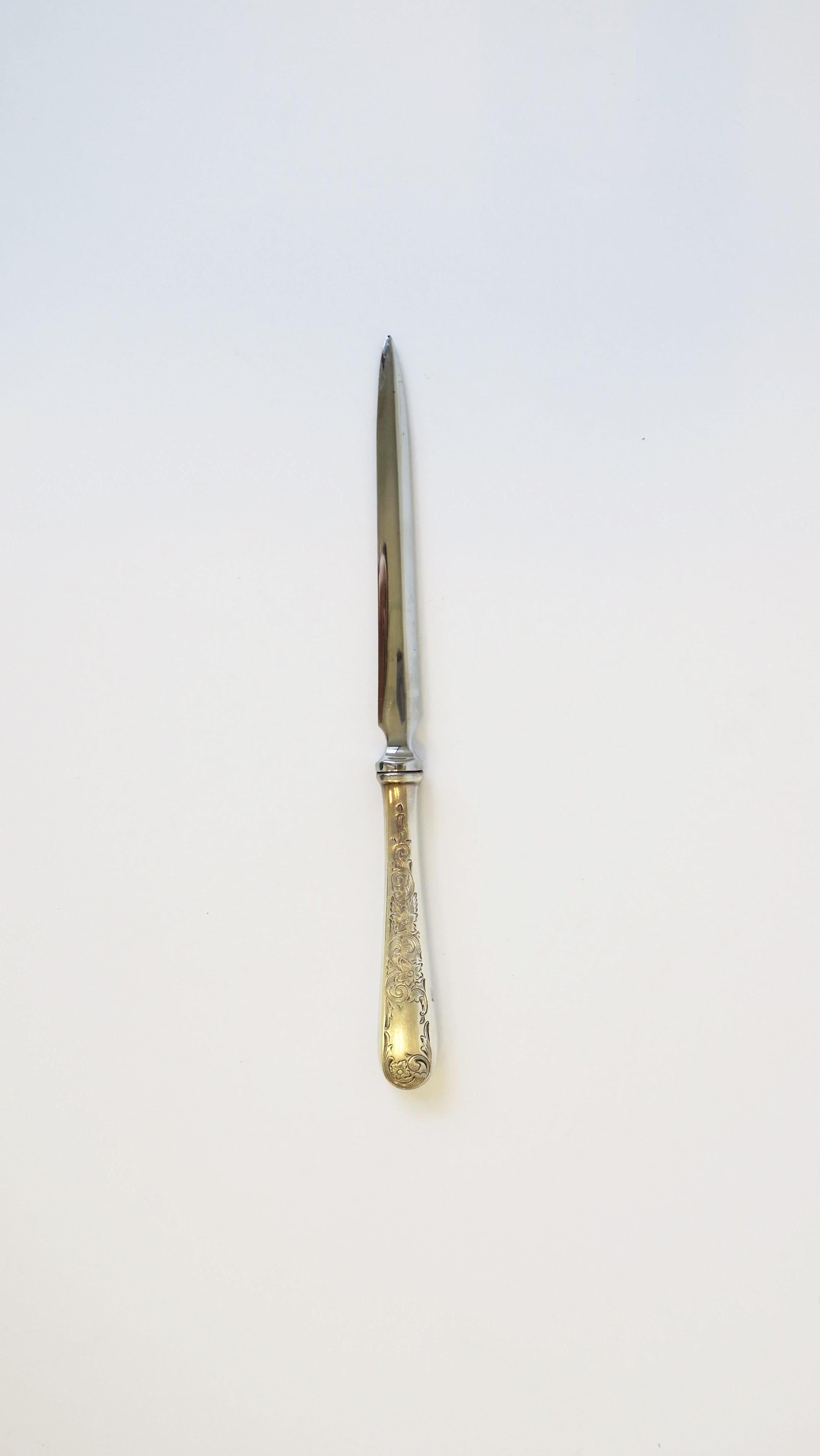 A beautiful vintage sterling silver and stainless-steel letter opener. Handle is sterling silver with decorative details. Blade is stainless-steel. Maker's mark and metal detail shown in image #12: By: Kirk Stieff. 

Measures: 7.75