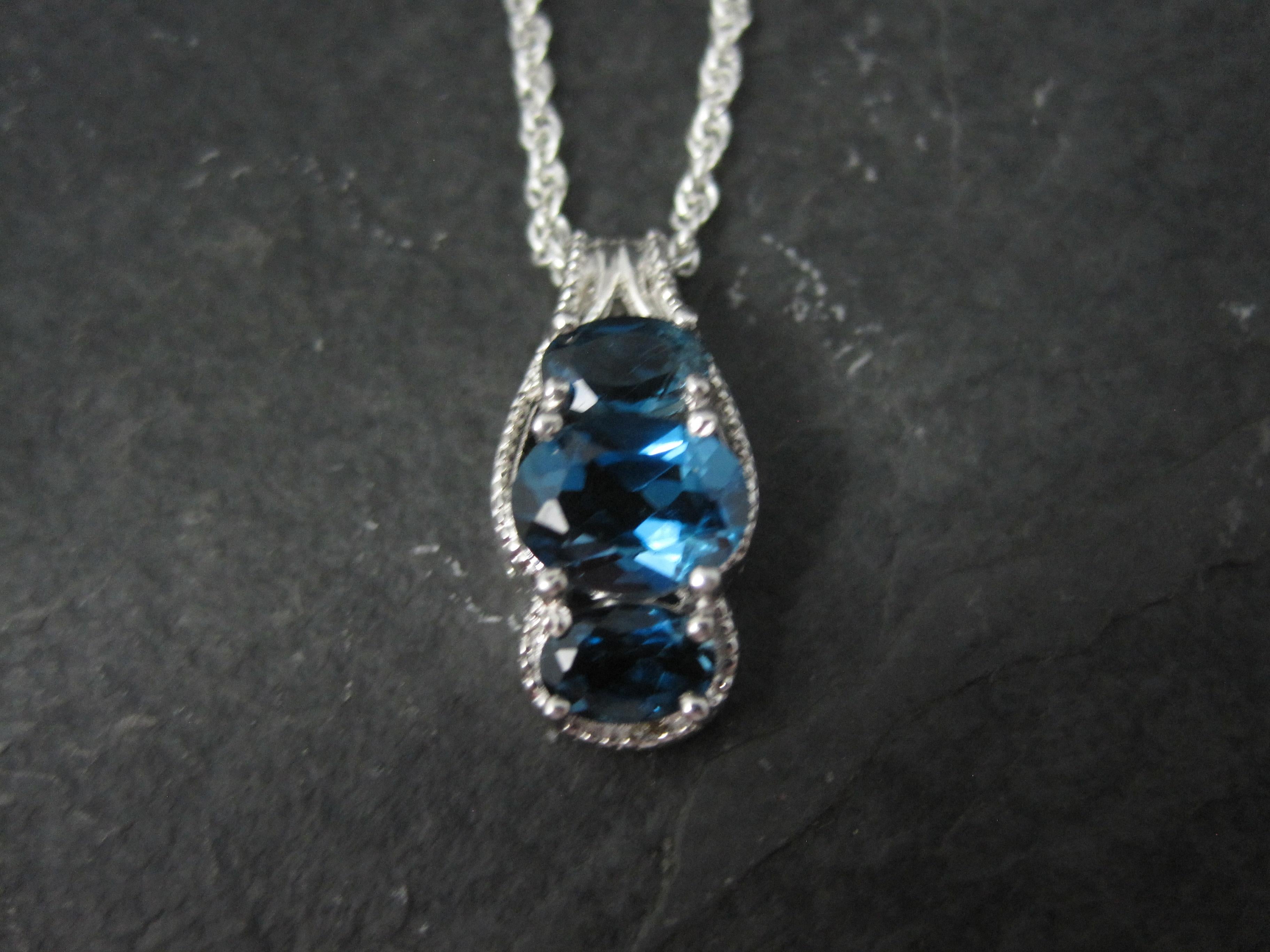 This gorgeous pendant is sterling silver.
It features a 3 stone combination of a 6x8mm and two 4x6mm oval cut, london blue topaz gemstones.

Measurements: 3/8 by 3/4 of an inch
Marks: 925, Chuck Clemency's STS hallmark

Comes on an 18 inch, sterling