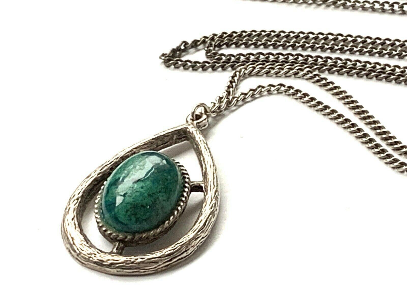 Sterling Silver Necklace 
Unknown stone 
Dark green with surface design - possibly hand painted ?
The chain has no clasp 
and is slip over .
The hallmark is set on the pendant as there is not 
a place to hallmark the chain -
the hallmark on the