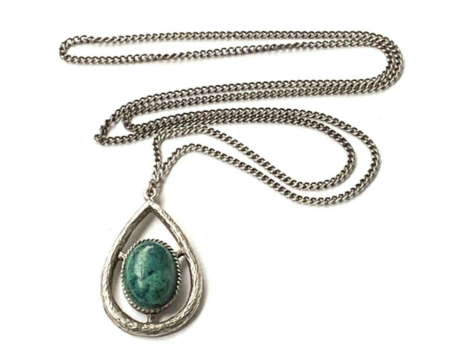 silver necklace with green stone
