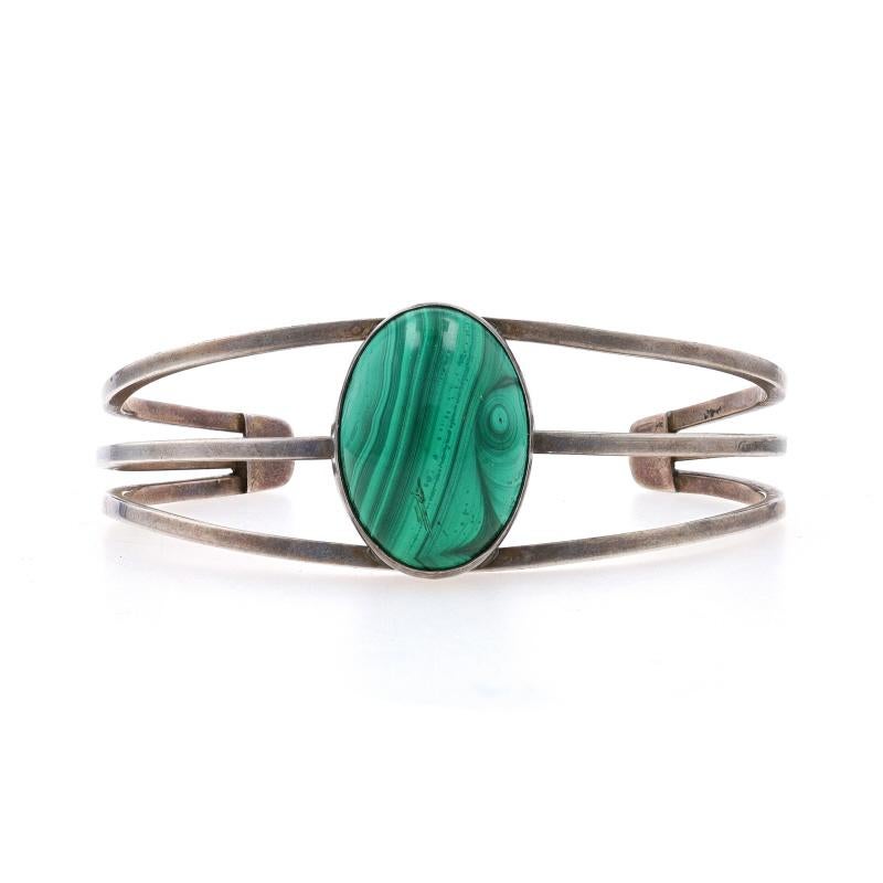 Design: Southwestern

Metal Content: Sterling Silver

Stone Information
Natural Malachite
Cut: Oval Cabochon
Color: Green

Style: Cuff
Fastening Type: N/A (slides over wrist)

Measurements
Inner circumference (including the opening): 6 3/4