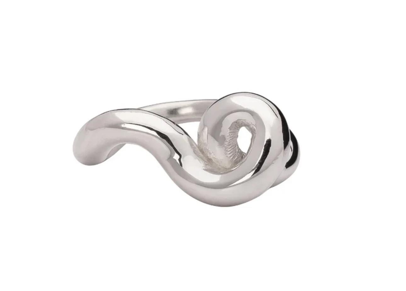 The Sterling Silver Mangala Curl Ring by Ariana Boussard-Reifel is a striking piece that elegantly wraps around the finger with fluid, curling lines. This ring captures modern sophistication and timeless beauty, making it a versatile addition to any