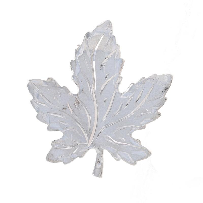 Metal Content: Sterling Silver

Style: Brooch
Fastening Type: Hinged Pin and Whale Tail Bullet Clasp
Theme: Maple Leaf
Features: Matte finish with etched detailing

Measurements
Tall: 1 1/32