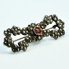 Sterling Silver Marcasite Red Paste Stone Flower and Leaf Bow Brooch circa 1930s