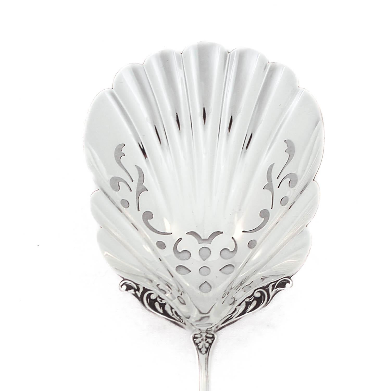 Being offered is a sterling silver serving spoon by Gorham Silversmiths in the “Maryland” pattern, hallmarked 1885.  The handle has a floral motif, not etched but raised.  The bowl is rather deep, scalloped, and has a cutout design.  This is