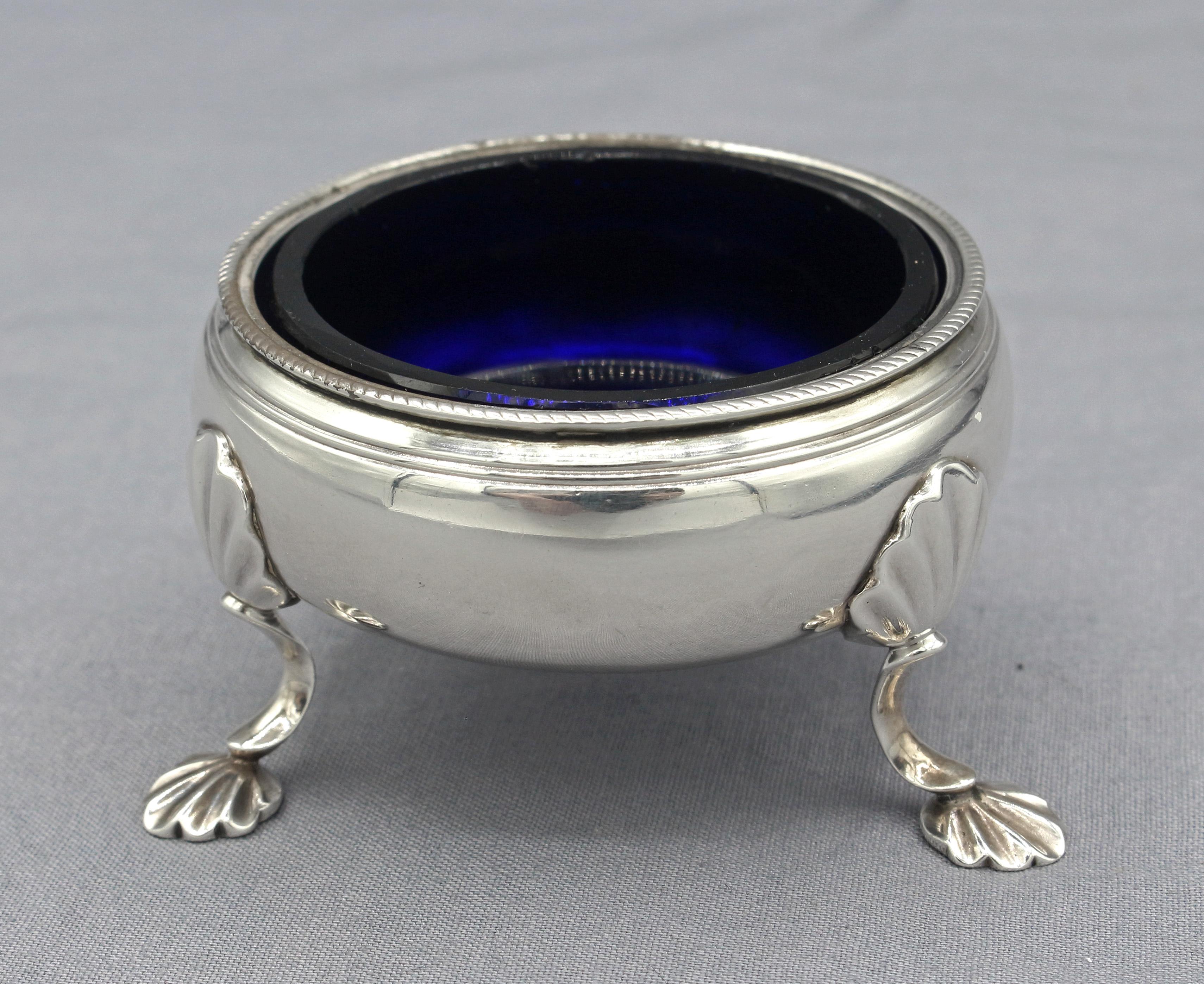Sterling silver master salt with later cobalt liner, London, 1759. George II period. Raised on 3 shaped legs surmounted by shells & ending in shell feet. Probably by William Bagnall (mark partially erased). 1.35 troy oz.
2 3/8