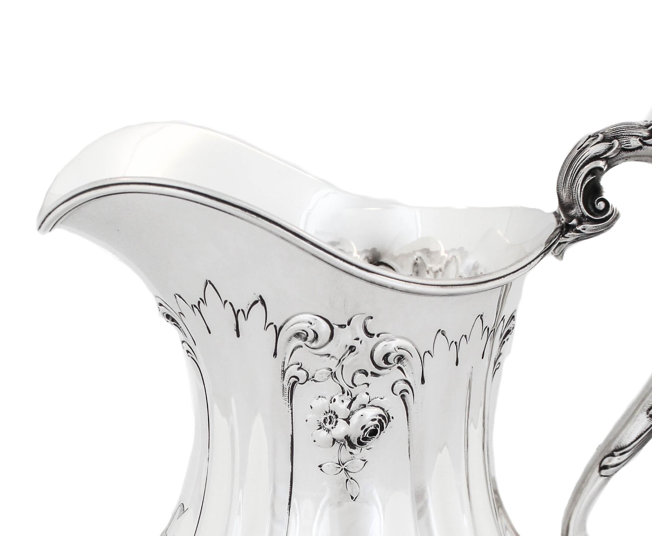Being offered is a sterling silver water pitcher by The Mauser Manufacturing Company of New York.  One of the most respected names in the sterling silver industry, Mauser is very sought after and collected.  Here we have a lovely example of a large