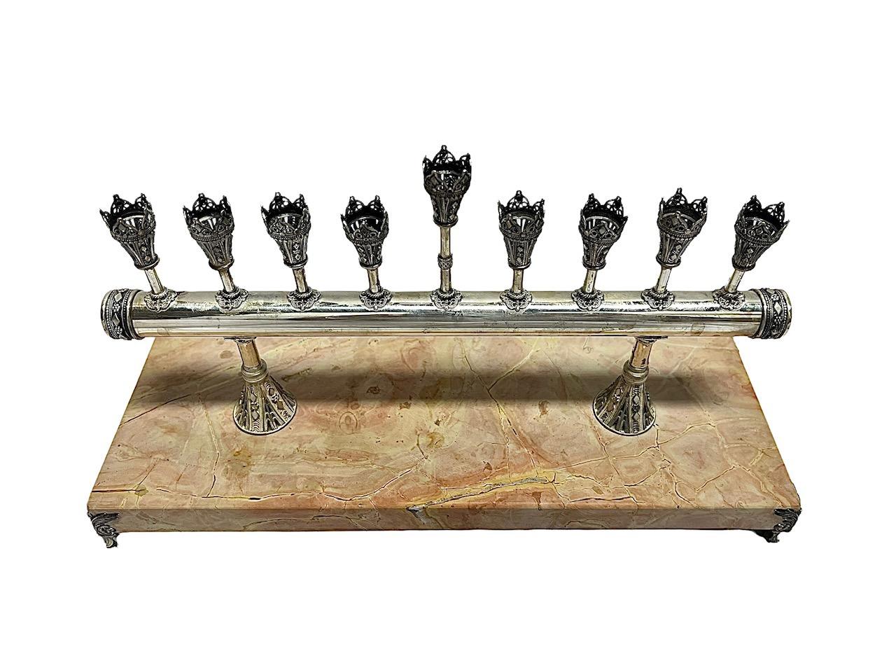 This sterling silver Menorah by the renowned artist Ben-Zion David Yemenite is a masterpiece of craftsmanship and spiritual significance. Meticulously crafted, this Menorah features intricate hand-filigree work that beautifully captures the essence