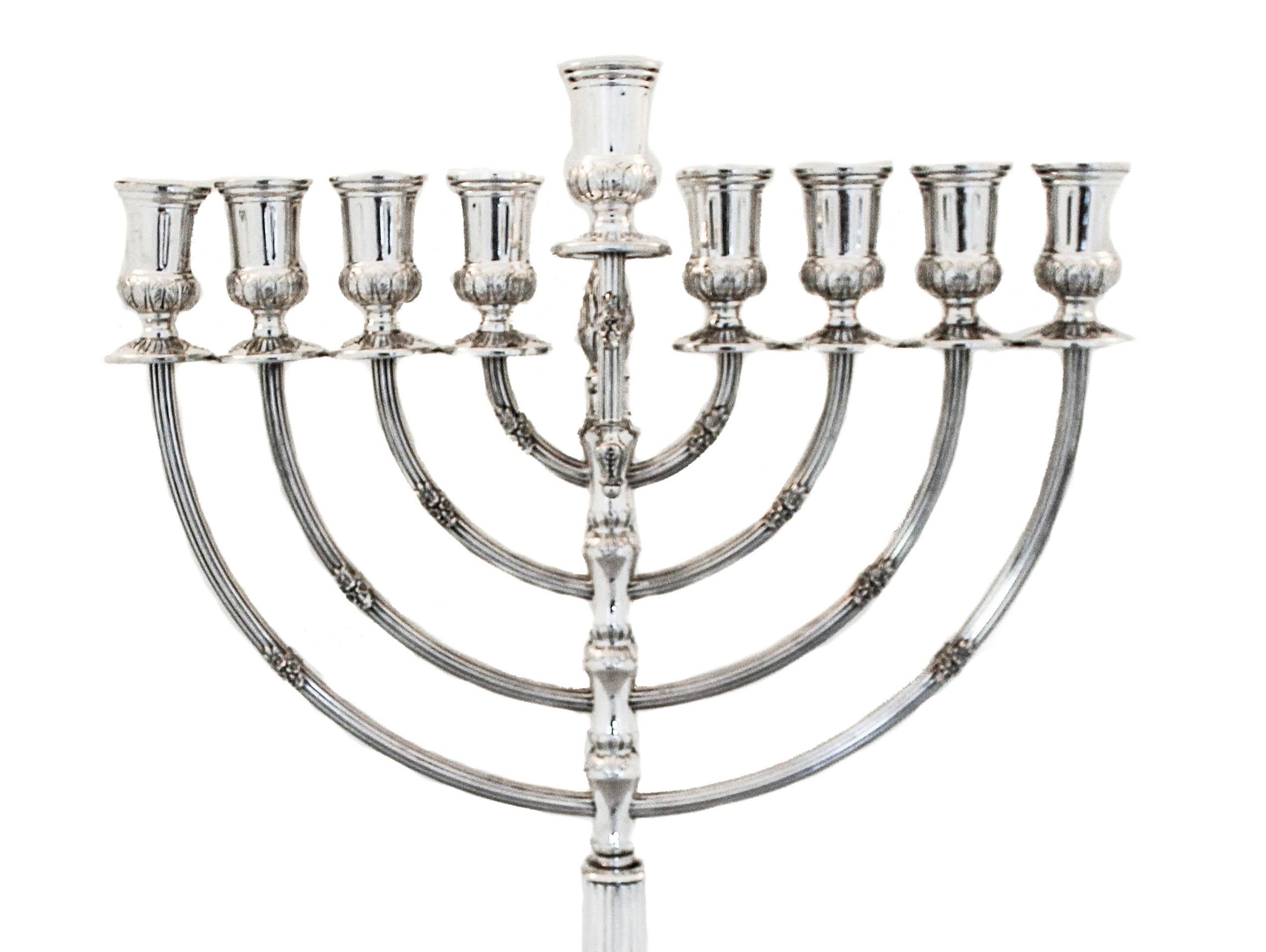 Just in time for Hanukkah we are happy to offer you this sterling silver menorah from Israel. It is regal and rich-looking. It has a square base and stands on four feet. There is a small floral motif on the branches along with ridges to give the