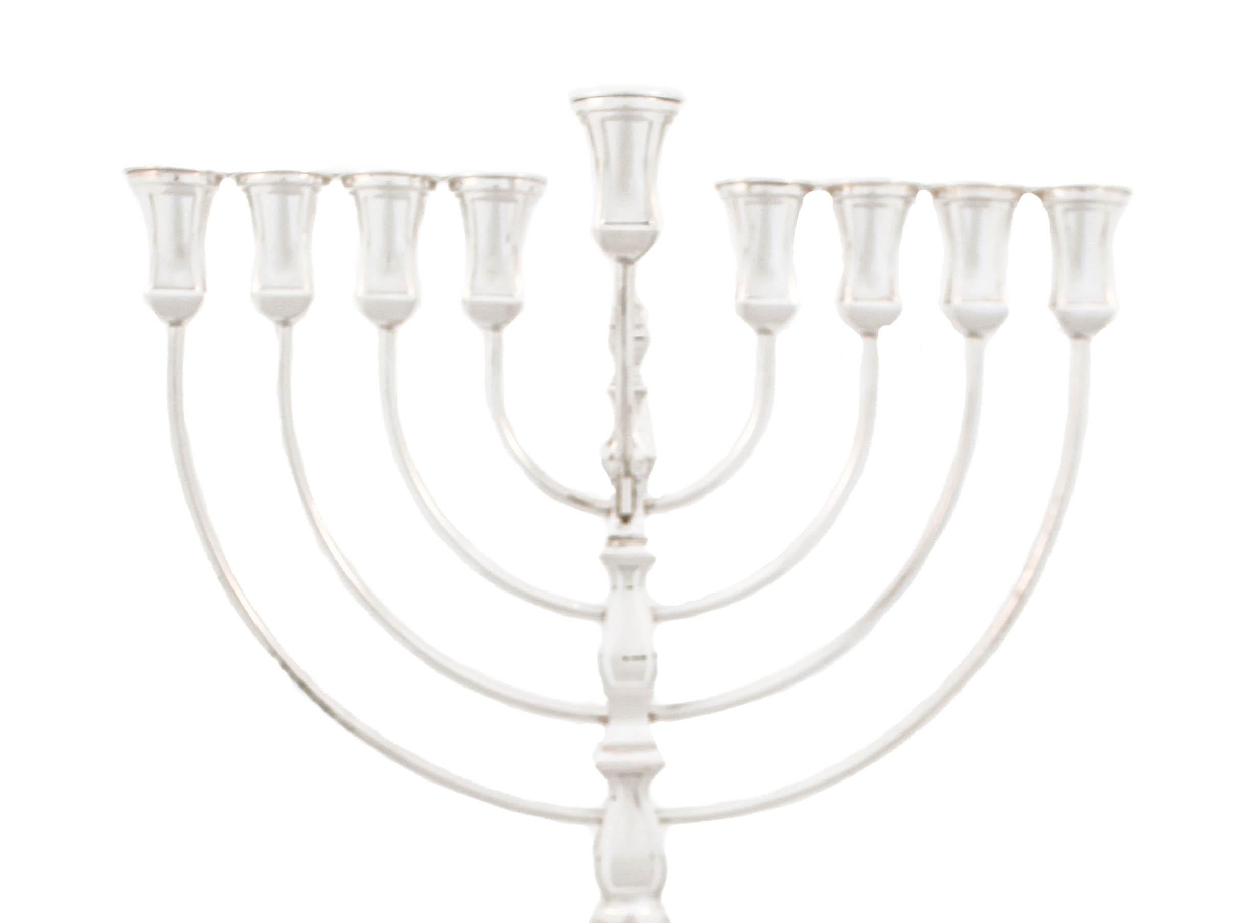 Being offered is a new sterling silver menorah.  Made in Israel it is modern and has a masculine feel with its straight lines and square shape.  The top and bottom unscrew in the center for easy storage.  It has a timeless classic design and a regal