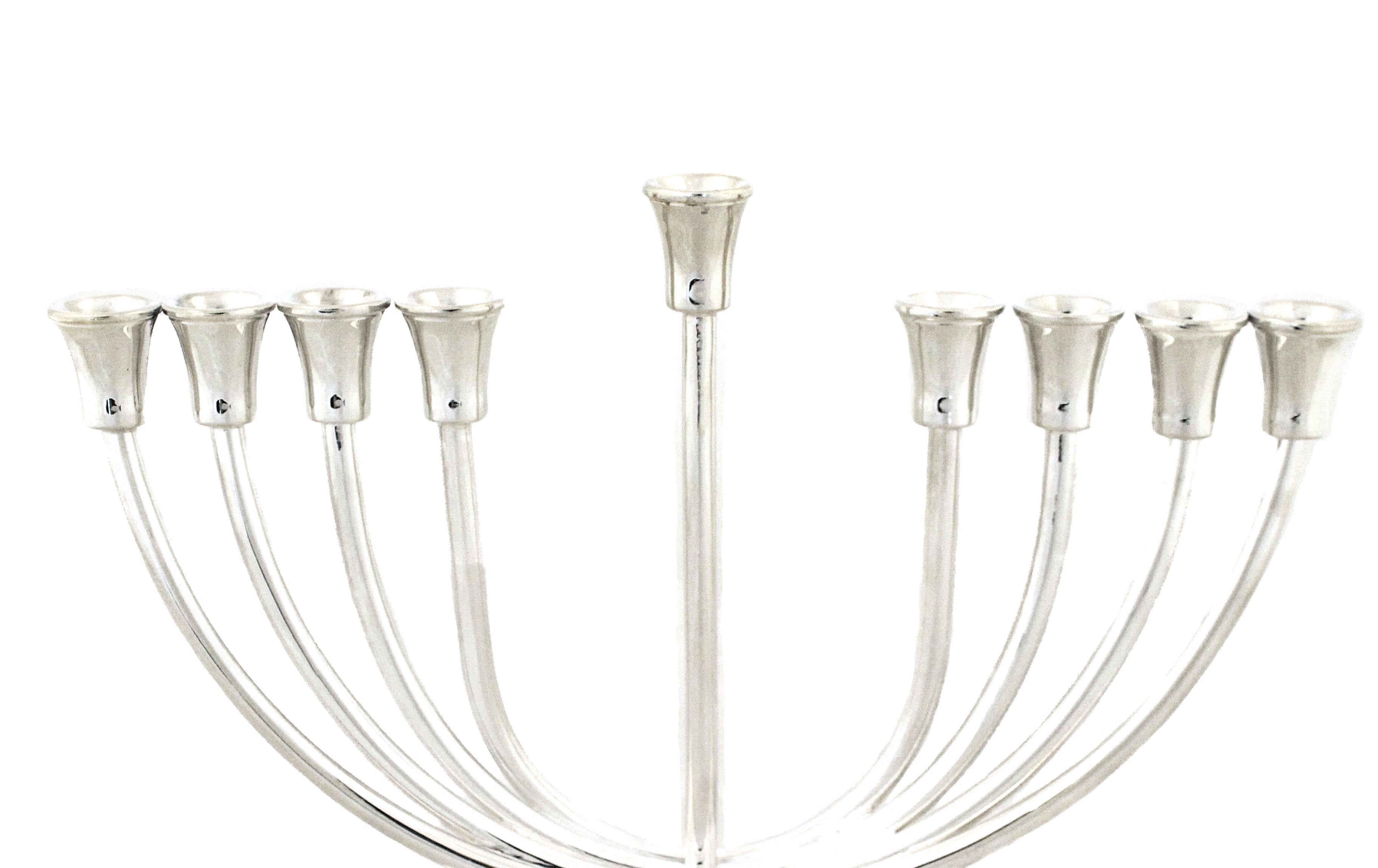 Being offered is a sterling silver menorah that is contemporary and beautiful.  Poised on an oval base the branches curve upwards and align evenly while the center arm is raised an extra inch.  A modern version of an age old tradition.  Happy