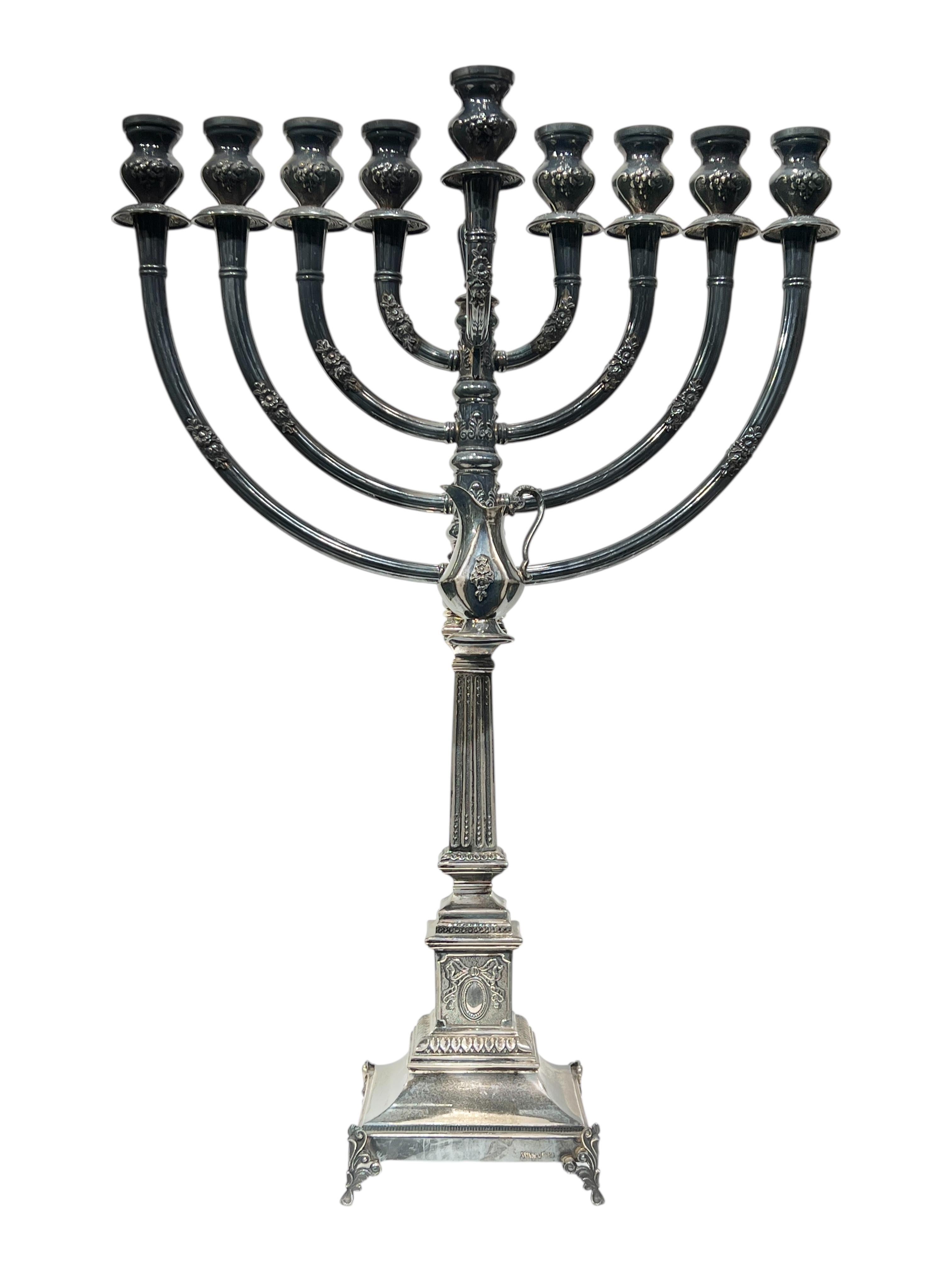 Large vintage menorah finely crafted in sterling silver from Hadad measuring 20 1/2 inches tall, 14 1/2 in wide and 4 3/4 in deep with its original Chanukah oil jug.  Stamped with the mark of the maker and 925. 
34 troy ounces.
