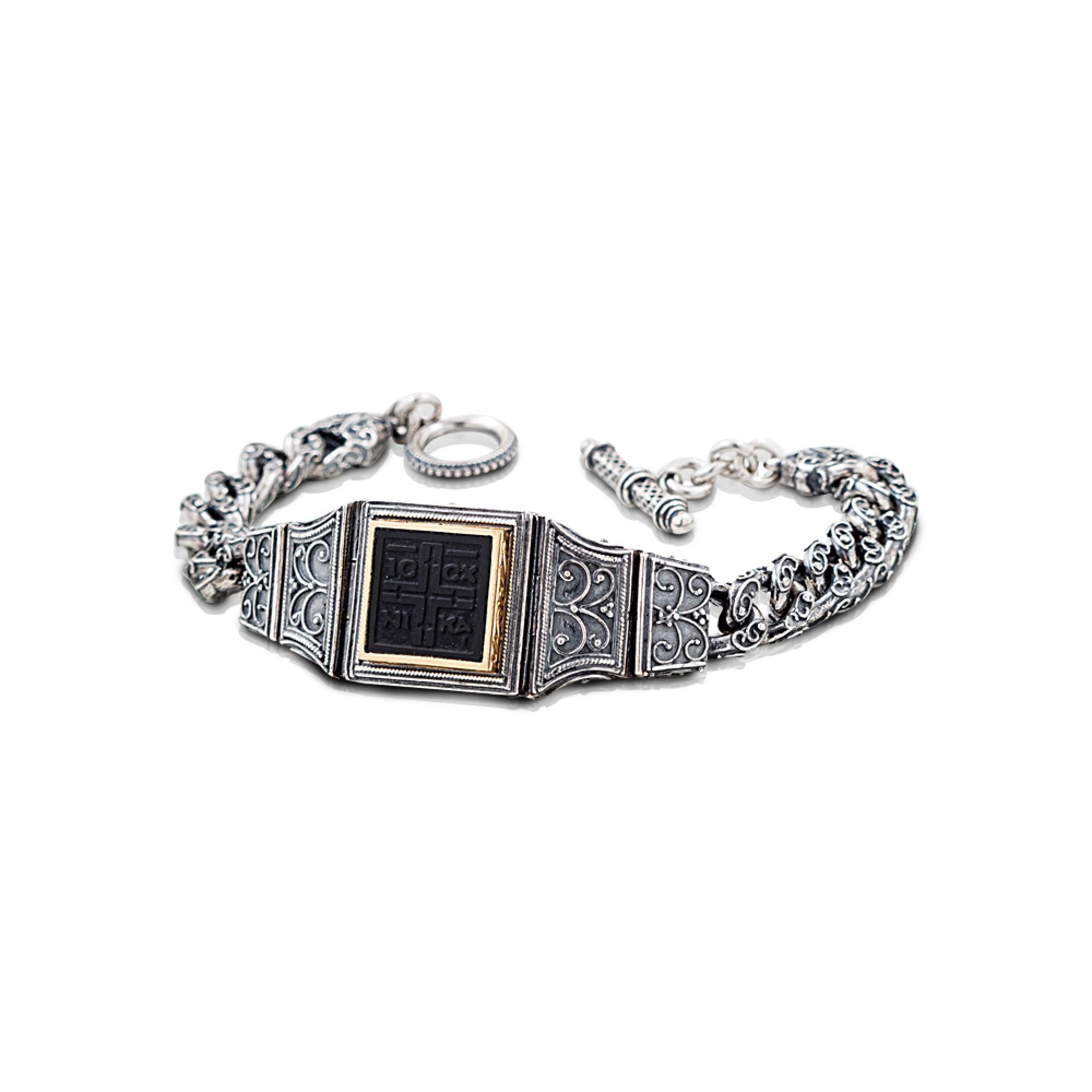 A refined bracelet with handmade chain inspired by Byzantine designs, made with embossed details and part of the Anax collection.

In the center, the IC XC NI KA can be seen engraved on a bronze tile.

In Orthodox Christianity the well known