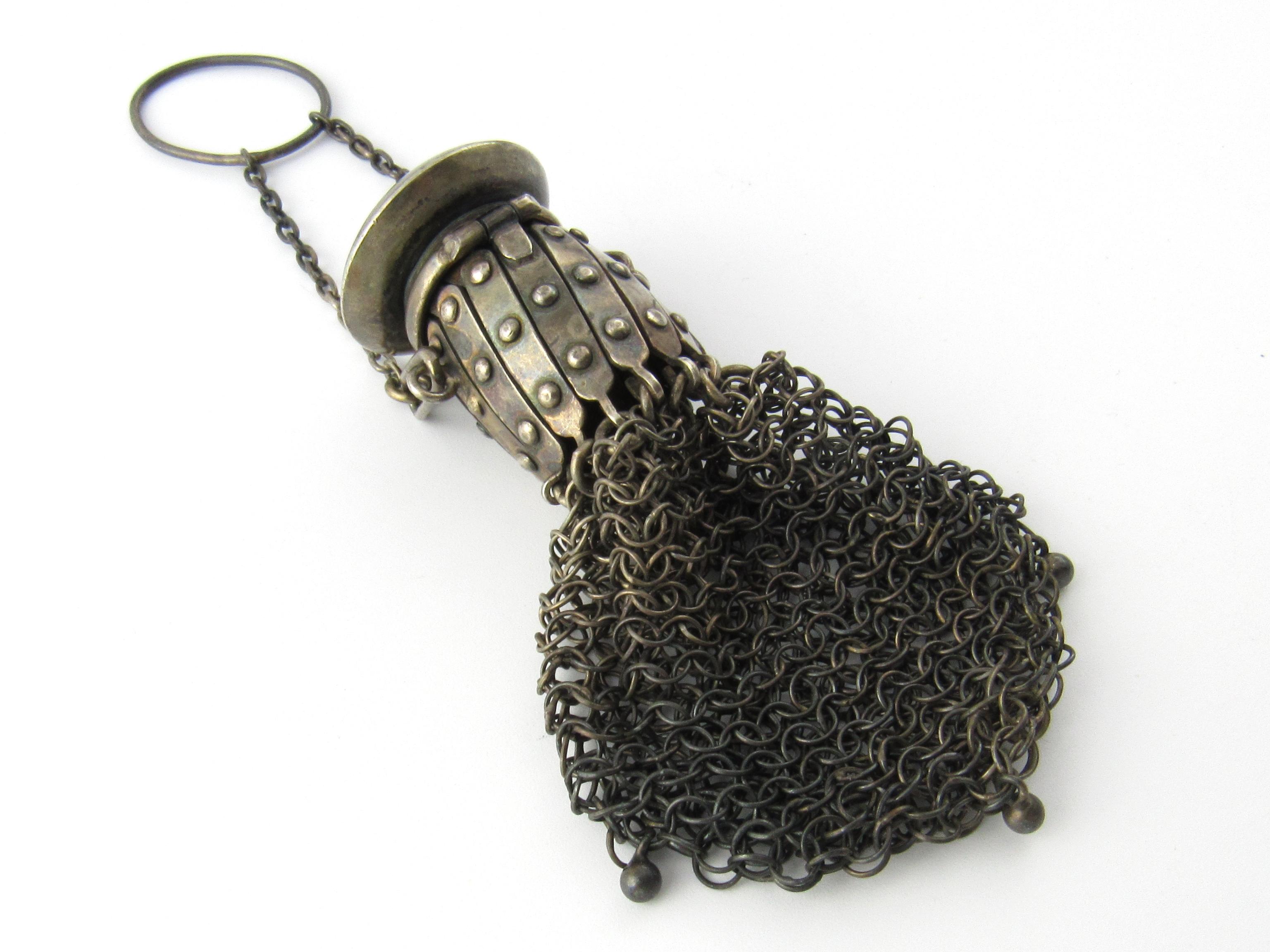 Antique Sterling Silver Mesh Accordion Coin Purse Monogram

This is a beautiful collectible mesh accordian coin purse with dangling beads on the bottom.

Measurement: Purse measures 3 and 1/2 inches in length, with handle measures 6 inches in