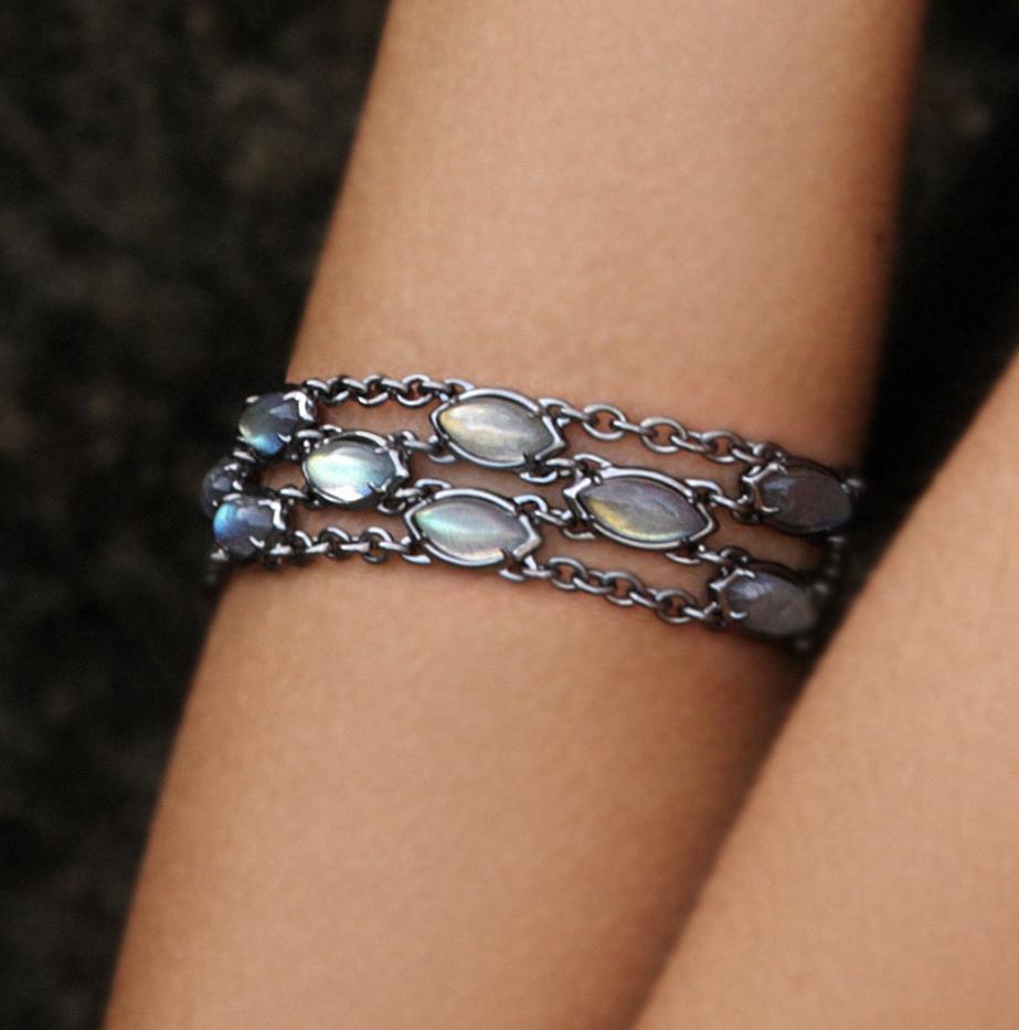 Lively labradorite marquise cabochon are integrated into a superbly sensual bracelet that you won't want to take off.
In sterling silver, this streamline 