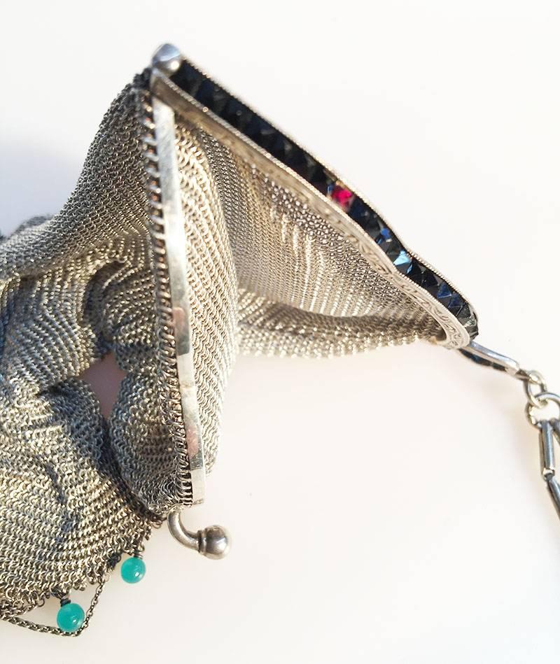 Sterling Silver Mesh Weave beaded bag

Sterling Silver mesh weave handbag with fringe and turquoise colored translucent stones, 13 pieces.
The opening of the purse has in one side of the opening 46 pieces pyramid cut grenades
This purse is marked