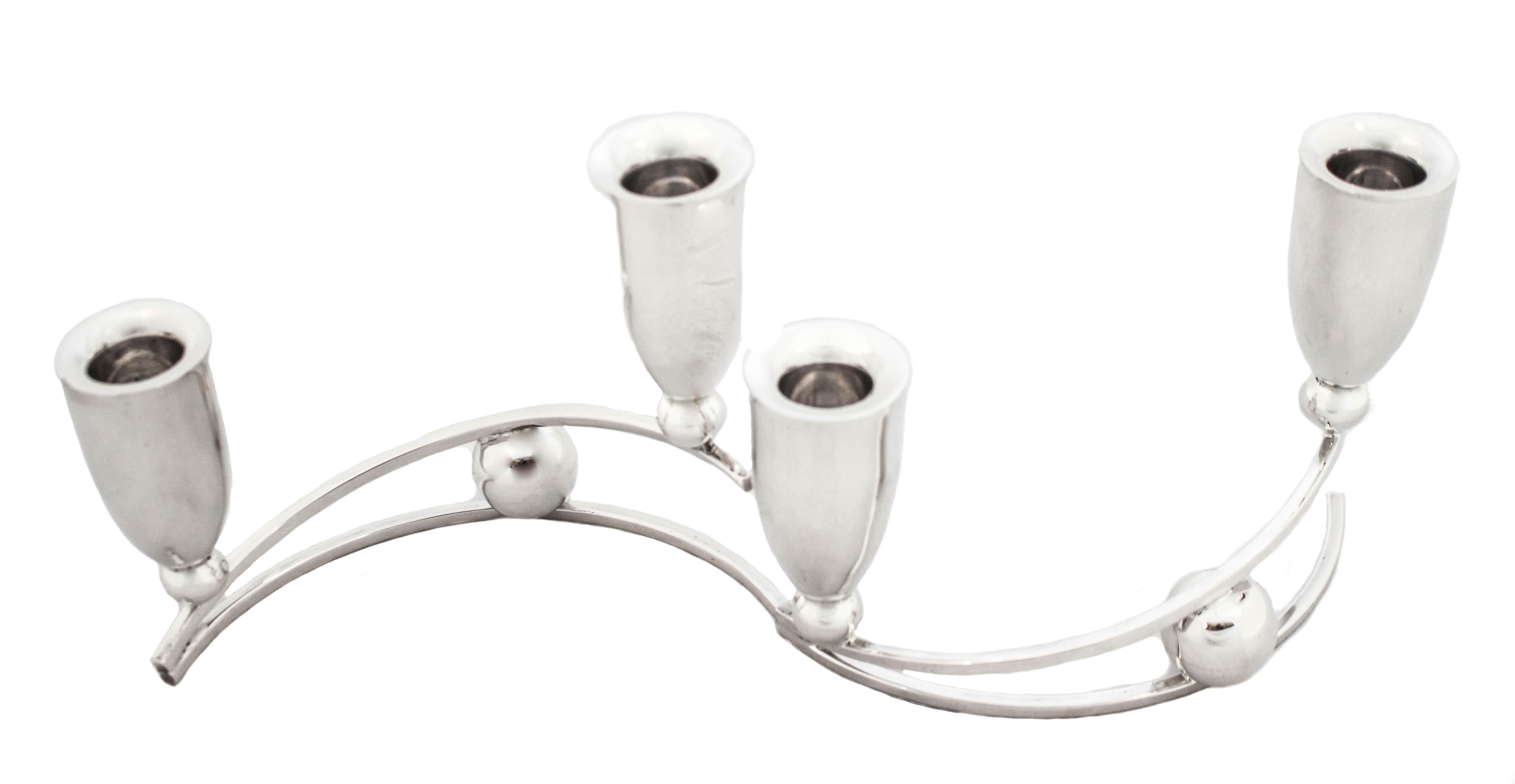 Pair of Mid-Century modern two-branch sterling silver candelabras being offered for sale.  This uber-modern sleek pair have that quintessential Mid-Century modernism look that’s so sexy and sought-after.  Each candleholder sits on a marble size