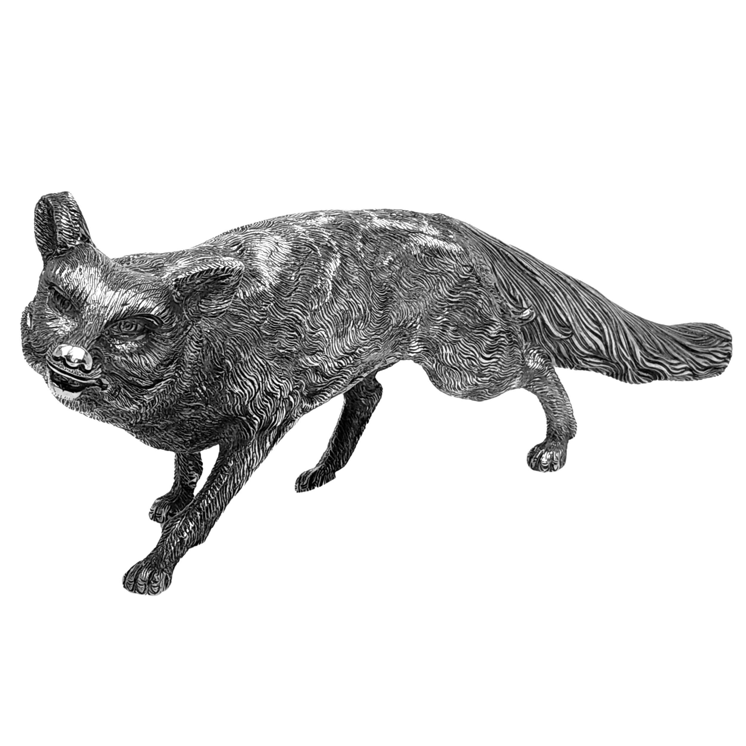 An excellent Solid Silver Model depicting a stalking Fox. This Sterling Silver Fox Figurine is of heavy weight and is modelled with a lovely attention to detail.

Made in Sheffield, England in 2000 by C J Vander.

Approx. Weight - 1430g /