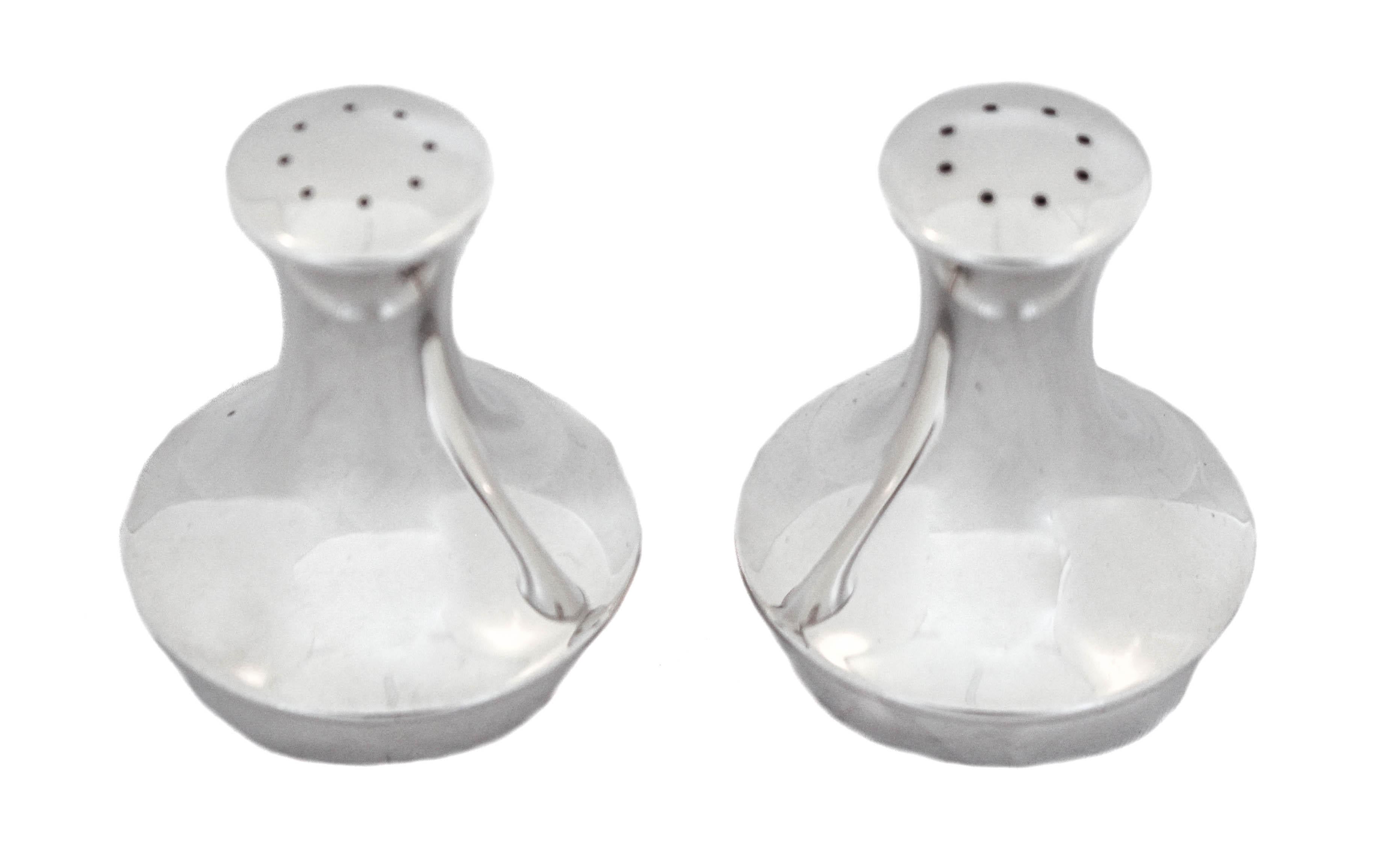 We love the sleek modernism look of these sterling silver salt shakers. Manufactured by Reed and Barton in the late 1950’s - early 1960’s, they have that quintessential Mid-Century modernism look and shape. Narrow on top with a wider base, they are