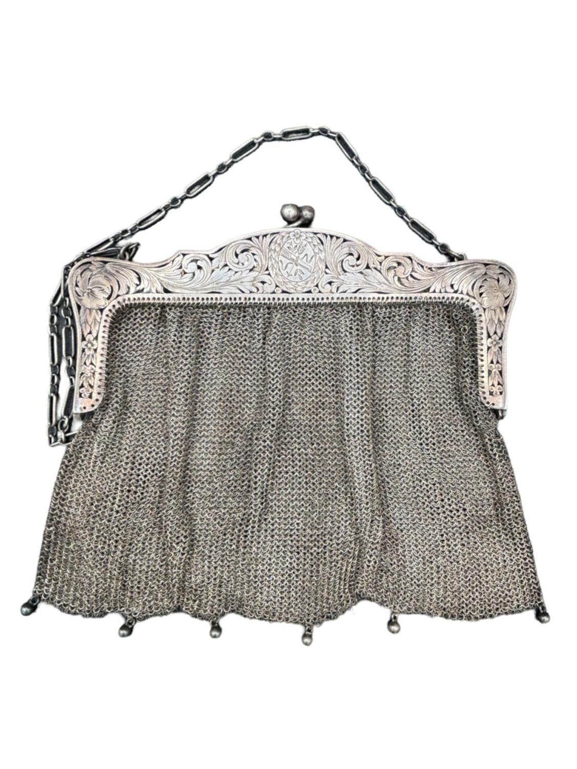 Late Victorian sterling silver chain mesh purse with a beautiful etching along the top clasp.

The chain handle was replaced with a steel chain 25 years ago.

With Clasps 6