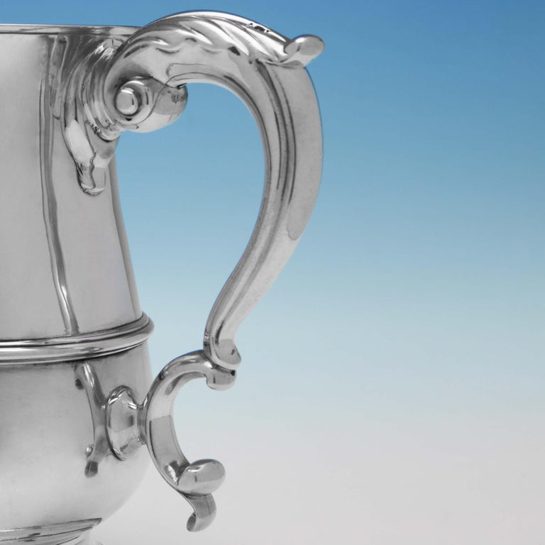 Hallmarked in London in 1771 by John King, this large and impressive Antique, George III, sterling silver 'quart' mug has an acanthus scroll handle. It measures 7
