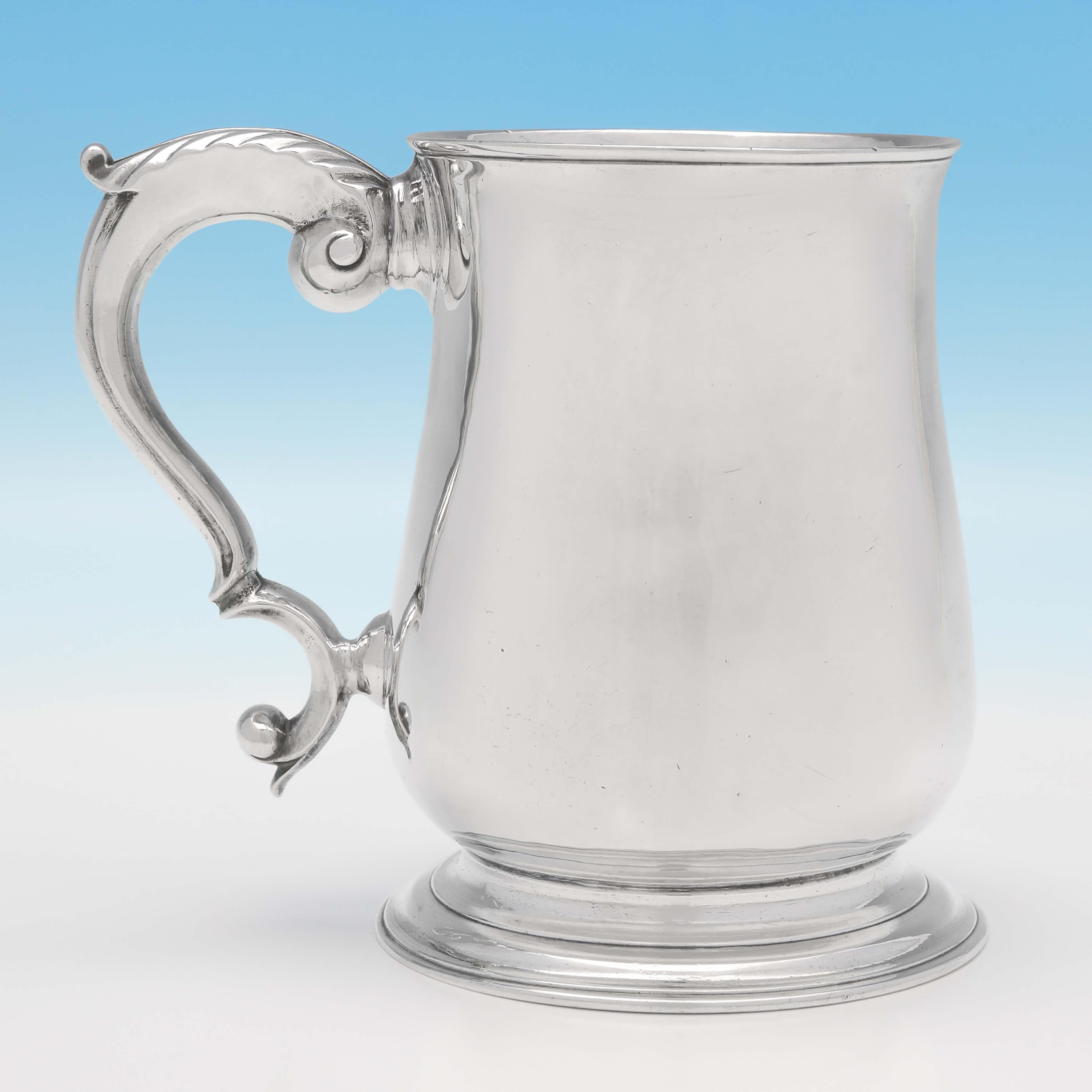 Hallmarked in London in 1748 by Fuller White, this fantastic antique, George II, sterling silver mug is hand raised, standing on a pedestal foot with an acanthus scroll handle. The mug measures: 5