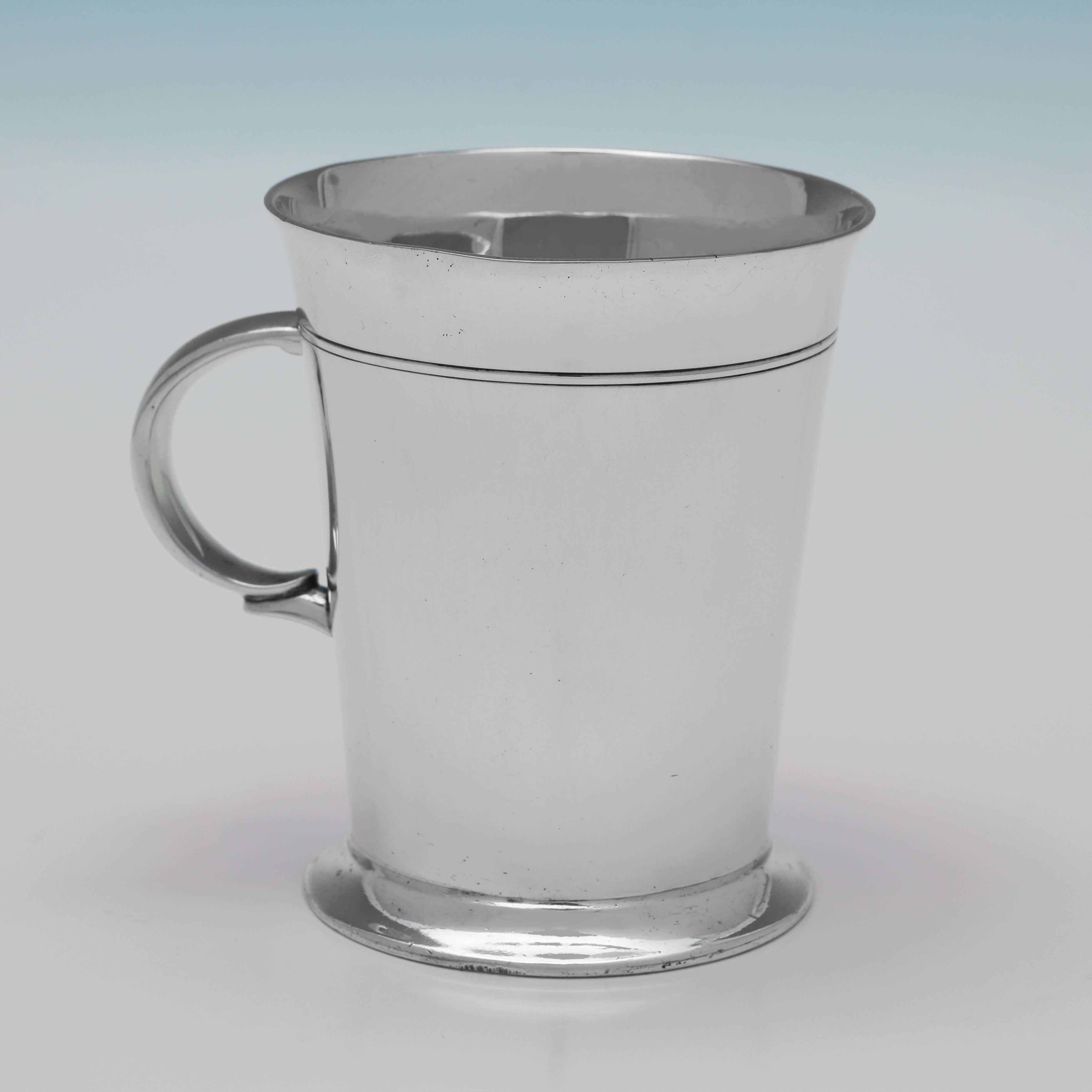 Hallmarked in Sheffield in 1935 by Roberts & Belk, this stylish, Sterling Silver Mug, is in the Art Deco taste, featuring reed detailing and a loop handle. The mug measures 3.75