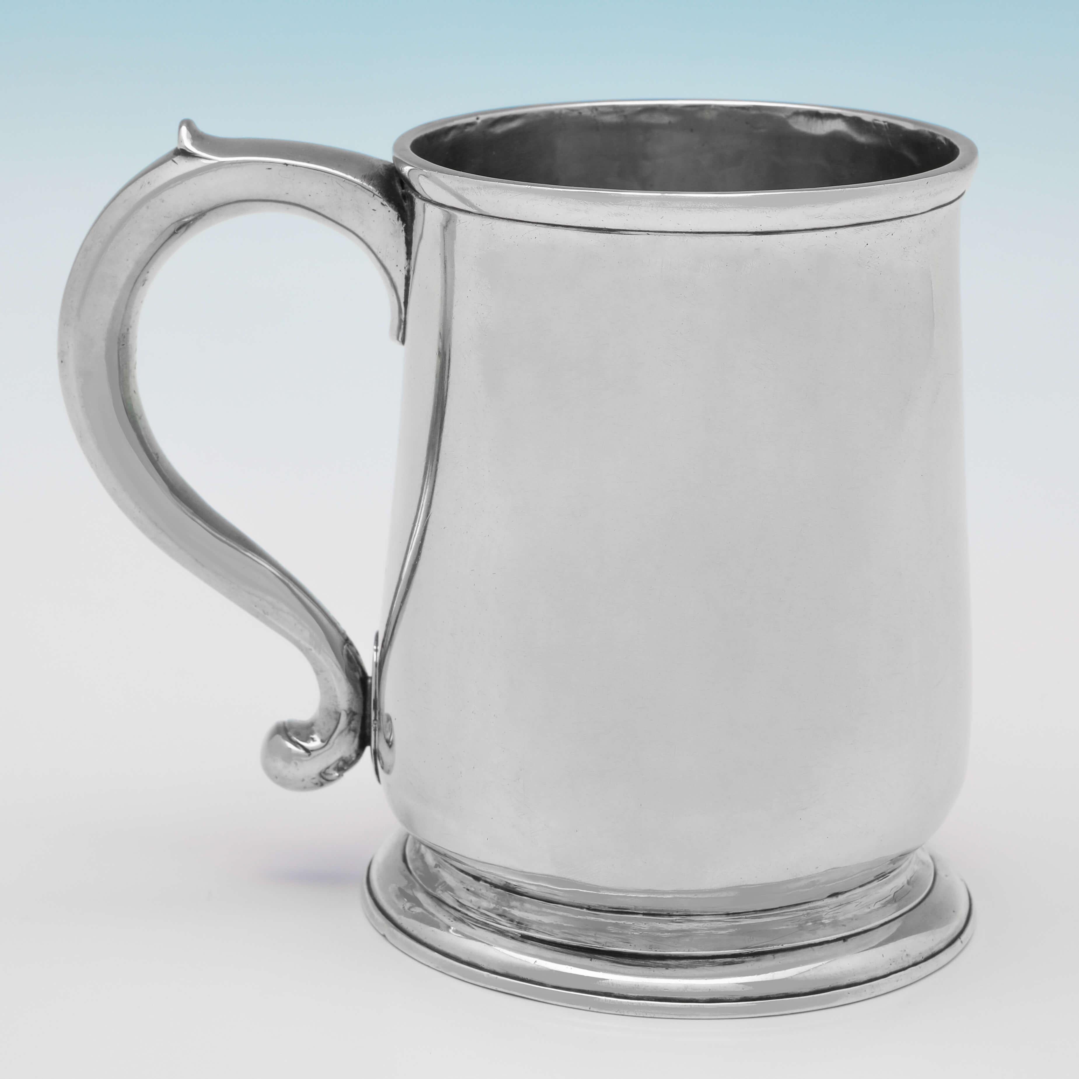 Hallmarked in London in 1727 by Richard Green, this handsome, George I, Antique Sterling Silver Mug, is plain in style, with reed detailing around the foot and rim. The mug measures 4.5