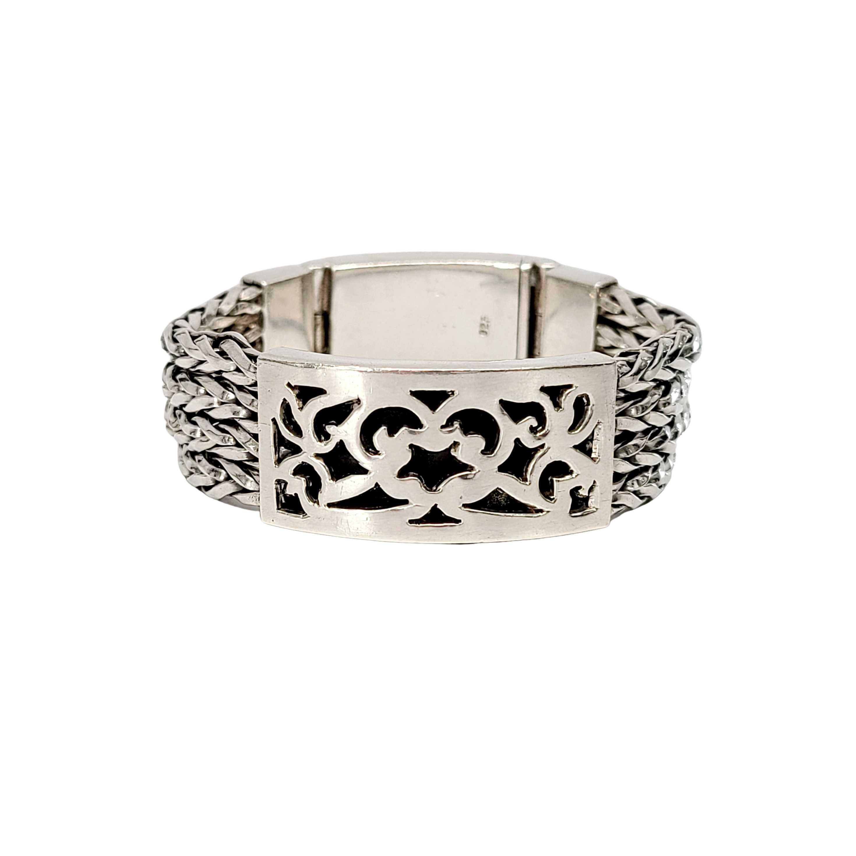 Sterling silver wheat box clasp bracelet.

This heavy and substantial bracelet features 4 thick woven/wheat strands, a rectangular station with open work scroll design sits at front. Large box slide clasp closure with safety lock.

Measures 6 1/4